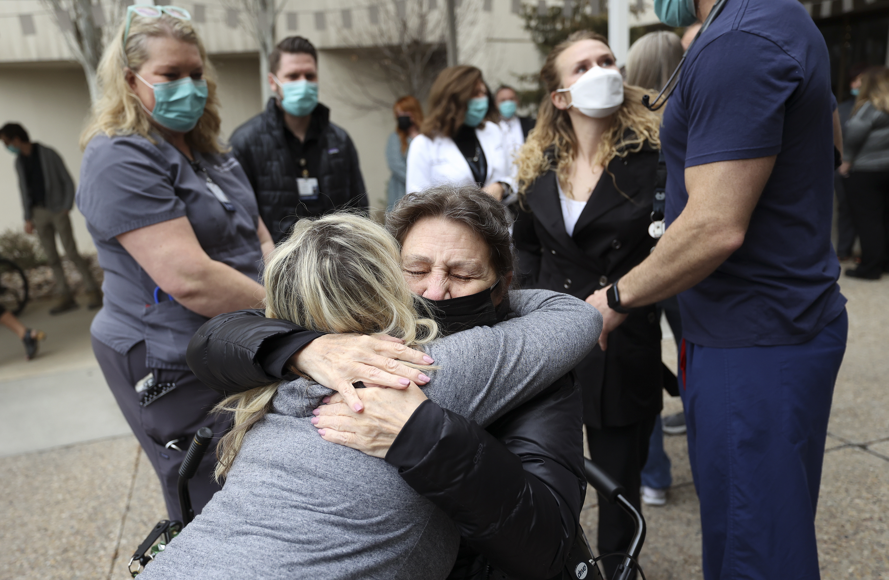 Cindy Rogers, St. Mark’s Hospital occupational therapy assistant, hugs Michelle Liechty, who spent 70 days at the hospital fighting COVID-19 and its aftereffects, during a COVID-19 memorial ceremony outside of St. Mark’s Hospital in Millcreek on Wednesday.