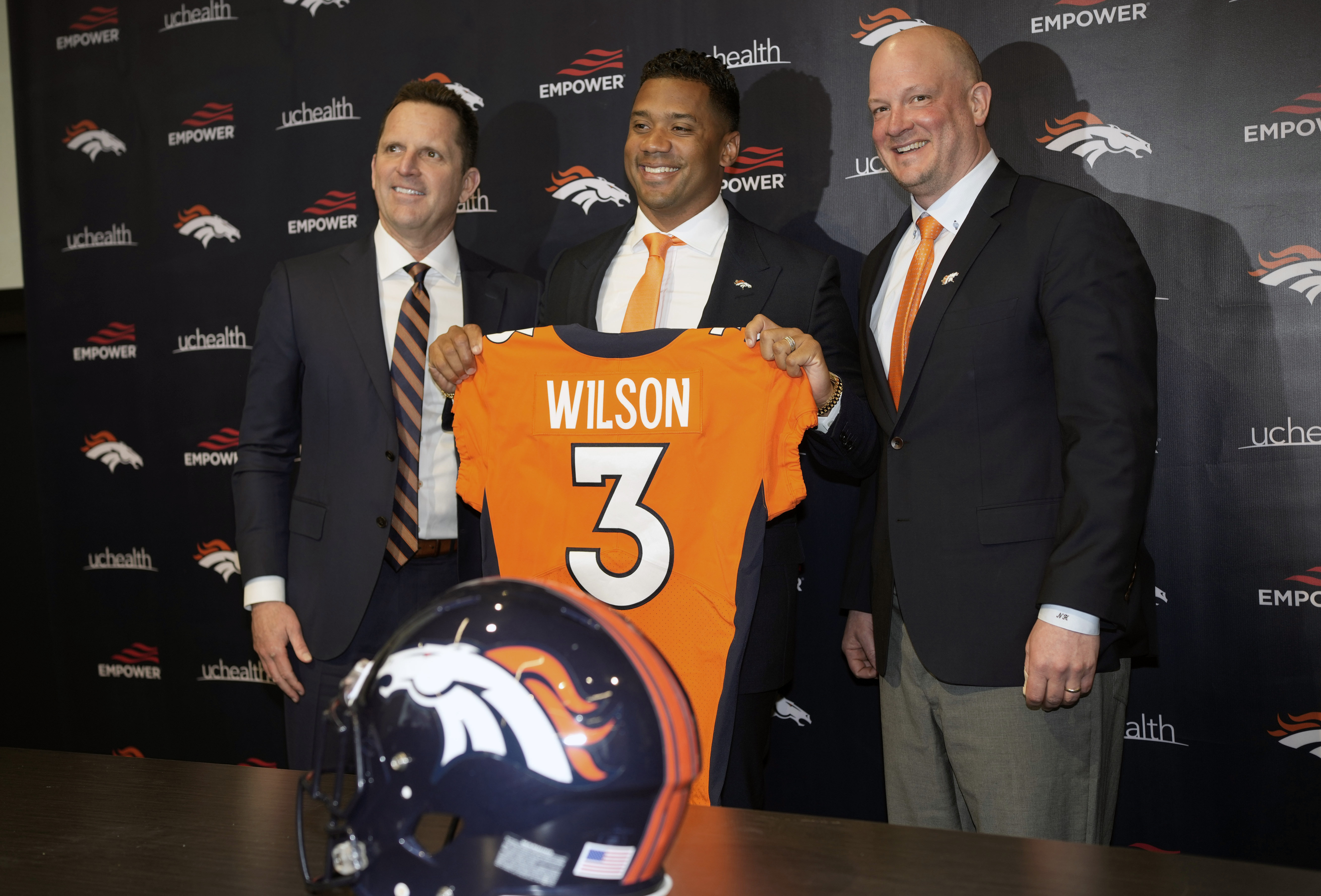 Denver Broncos new starting quarterback Russell Wilson, center, is flanked by head coach Nathaniel Hackett, right, and general manager George Paton after a news conference Wednesday, March 16, 2022, at the team's headquarters in Englewood, Colo. 