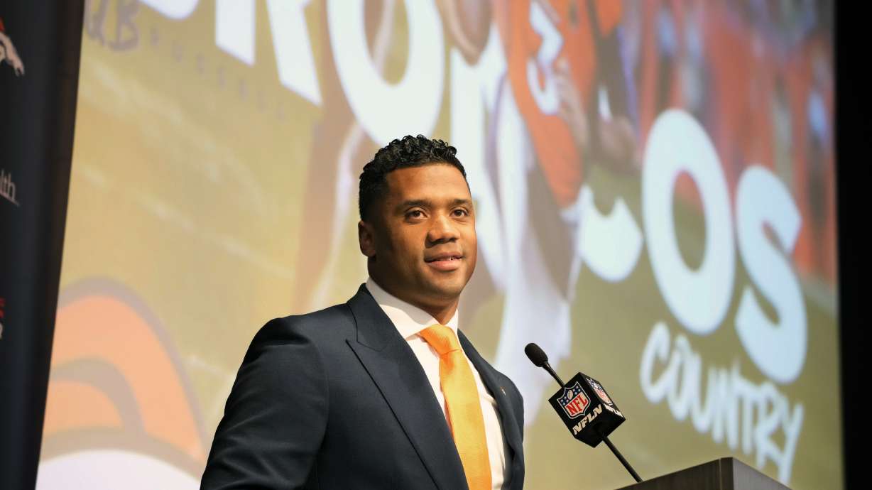 Denver Broncos new starting quarterback Russell Wilson speaks during a news conference Wednesday, March 16, 2022, at the team's headquarters in Englewood, Colo.
