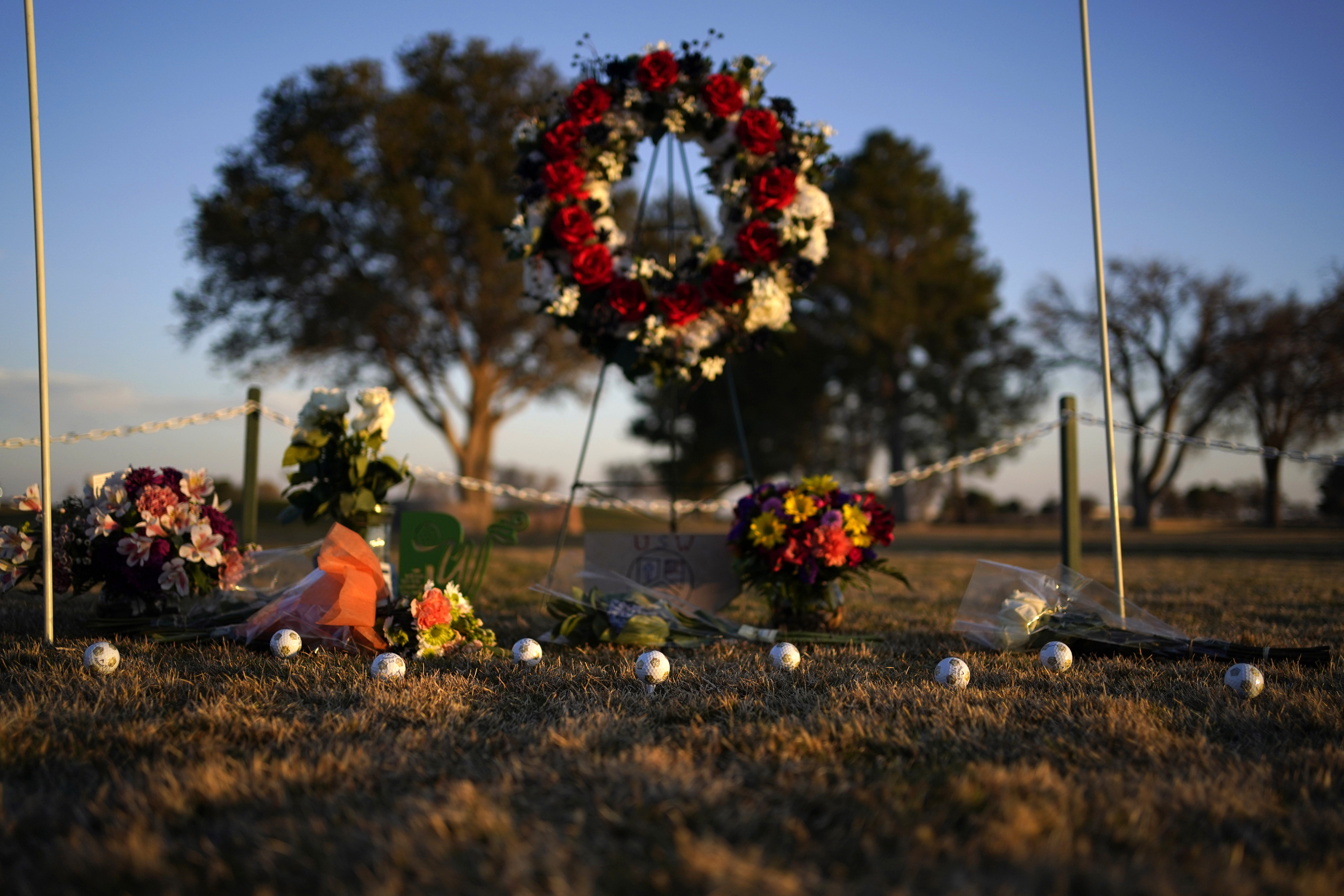 Golf balls adorn a makeshift memorial at the Rockwind Community Links, Wednesday, in Hobbs, N.M. The memorial was for student golfers and the coach of University of the Southwest who were killed in a crash in Texas.
