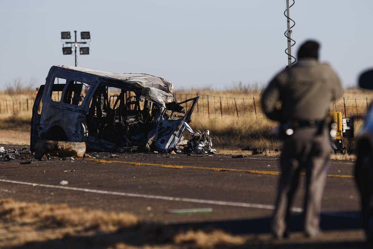 Texas Department of Public Safety Troopers look over the scene of a fatal car wreck early Wednesday half of a mile north of State Highway 115 on Farm-to-Market Road 1788 in Andrews County, Texas.