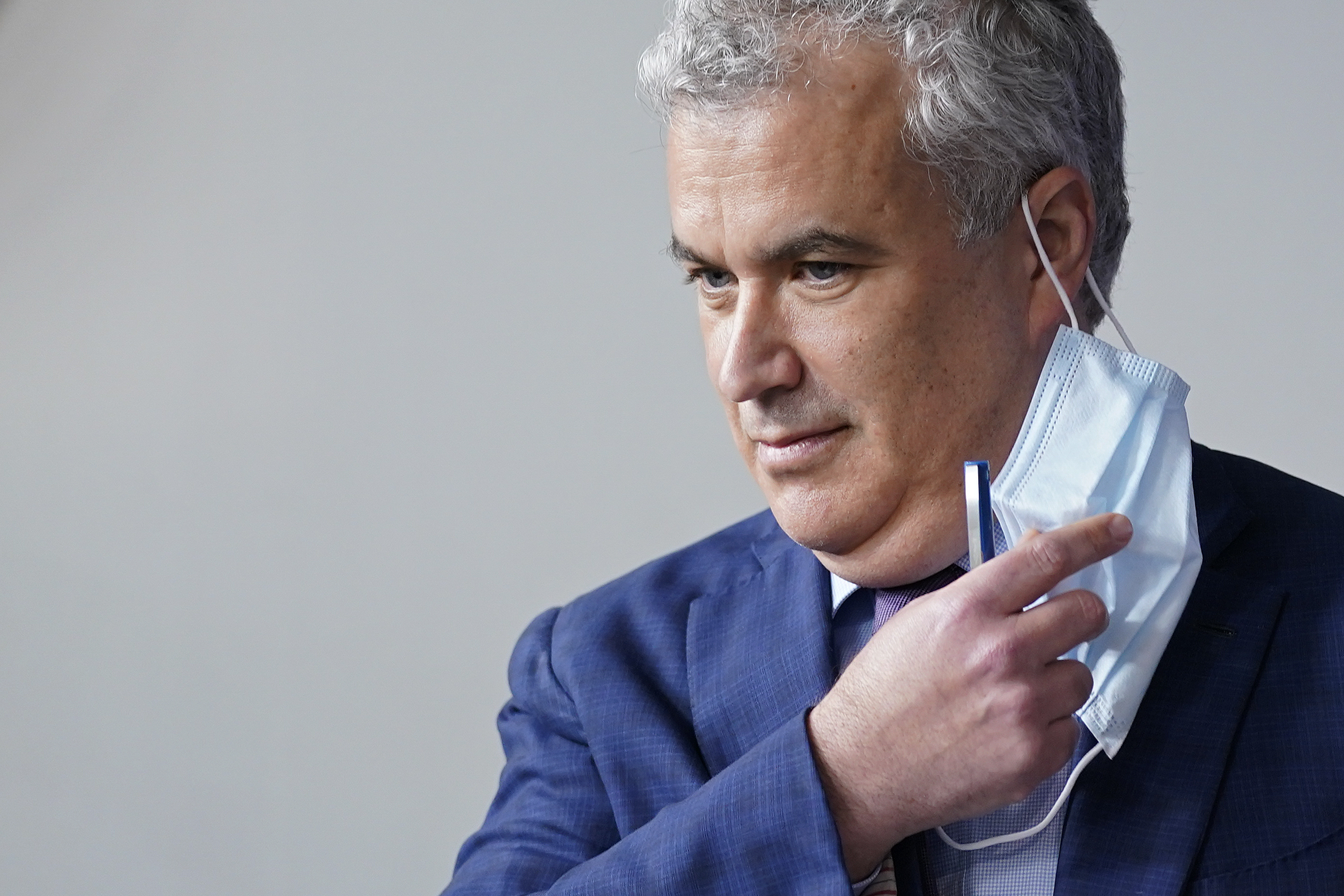 White House COVID-19 Response Coordinator Jeff Zients removes a face mask as he prepares to speak at a press briefing at the White House, April 13, 2021, in Washington. Zients and his deputy Natalie Quillian are leaving the administration next month.
