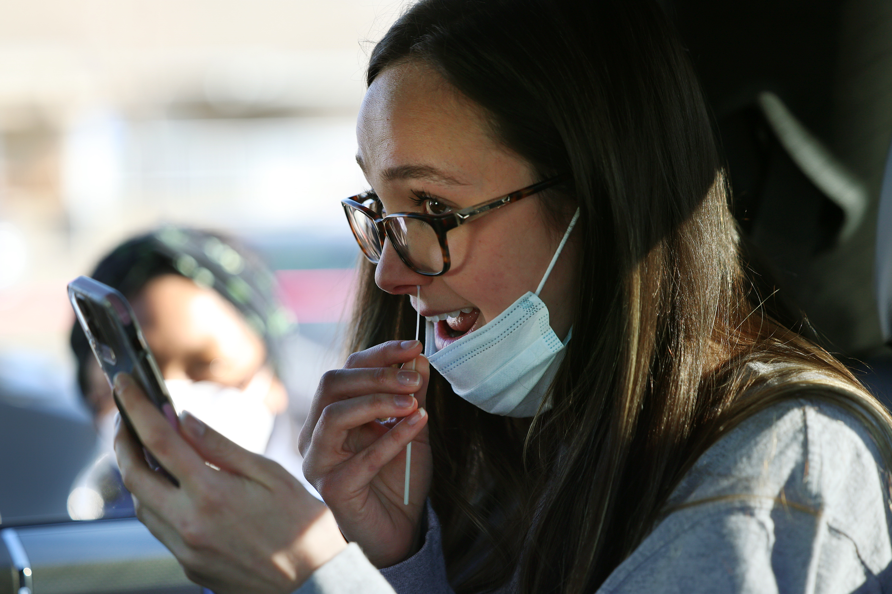 Caiden Bishop swabs her nose for a COVID-19 test at the University of Utah in Salt Lake City on Jan. 31. Utah health officials reported 343 new COVID-19 cases since Friday, as well as 12 additional deaths.