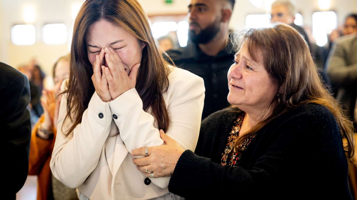 Yeona Bae, originally from South Korea, bursts into tears and is comforted by Viviana Vicencio, from Chile, after they both became U.S. citizens during a naturalization ceremony at This Is the Place Heritage Park in Salt Lake City on Thursday.