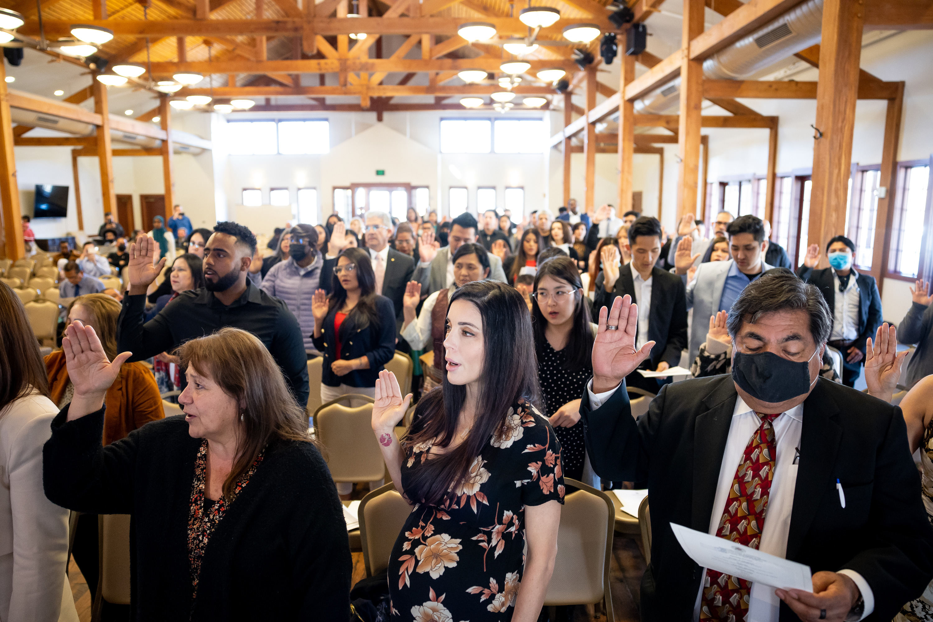 Silvia Cammack, center, originally from Spain, recites the oath of allegiance along with other new U.S. citizens during a naturalization ceremony at This Is the Place Heritage Park in Salt Lake City on Thursday, March 17.