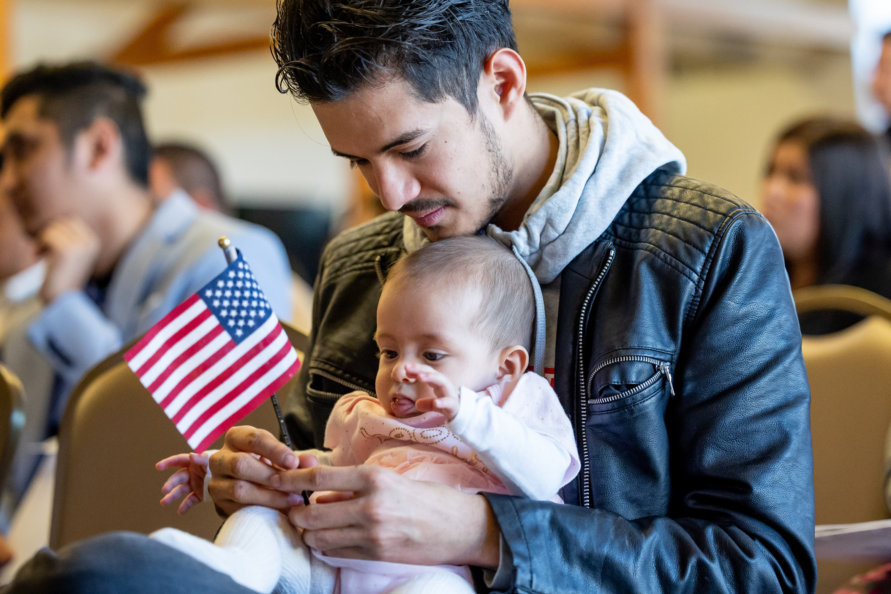 Isidro Bautista, originally from Mexico, holds his 6-month-old daughter, Ximena, after Bautista became a U.S. citizen during a naturalization ceremony at This Is the Place Heritage Park in Salt Lake City on Thursday, March 17.