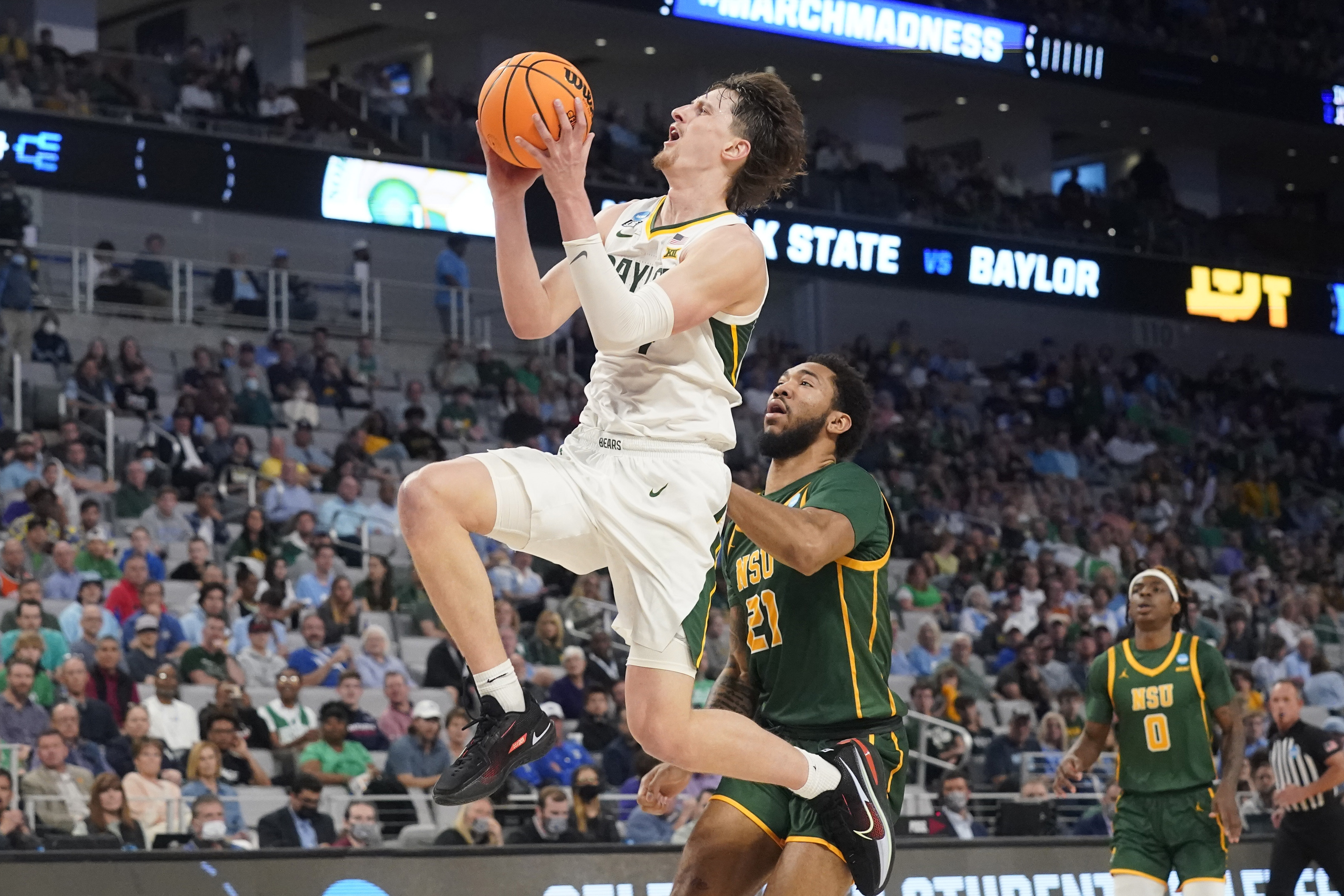 Baylor guard Matthew Mayer, left, drives past Norfolk State forward Dana Tate (21) during the second half of a college basketball game in the first round of the NCAA tournament in Fort Worth, Texas, Thursday, March 17, 2022.