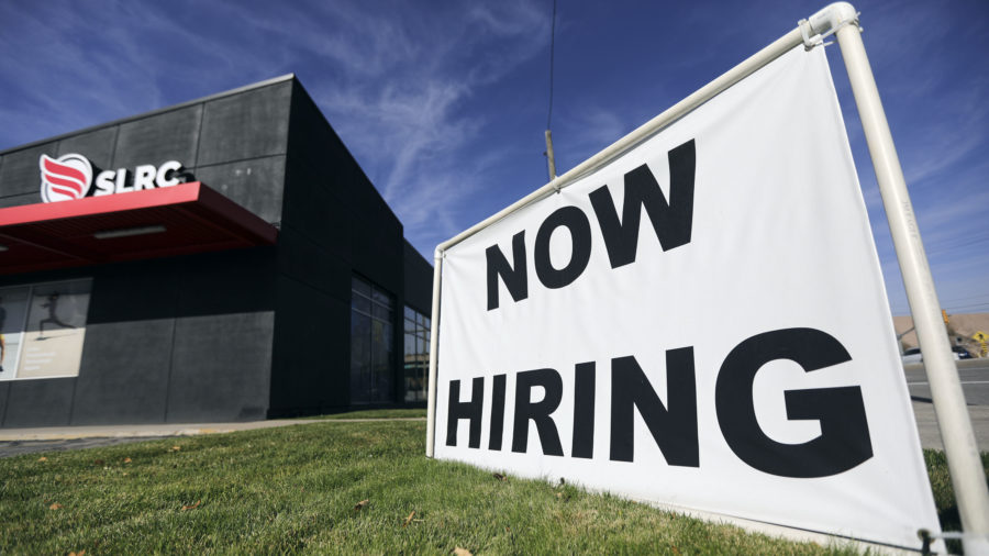 A “now hiring” sign is pictured at Salt Lake Running Company in Salt Lake City on Nov. 5, 2021.