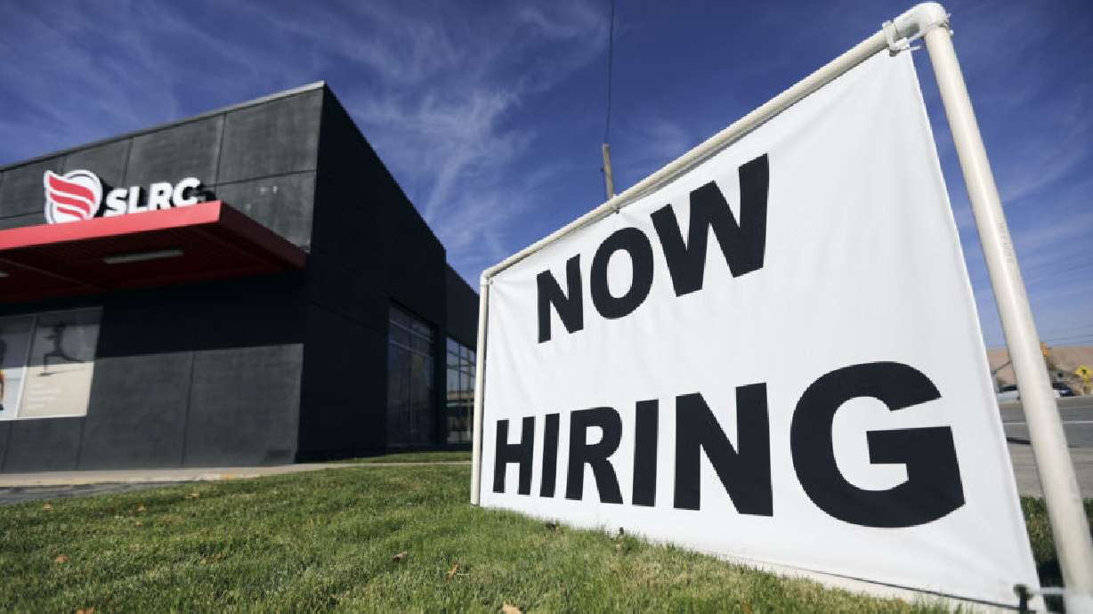 A “now hiring” sign is pictured at Salt Lake Running Company in Salt Lake City on Nov. 5, 2021.
