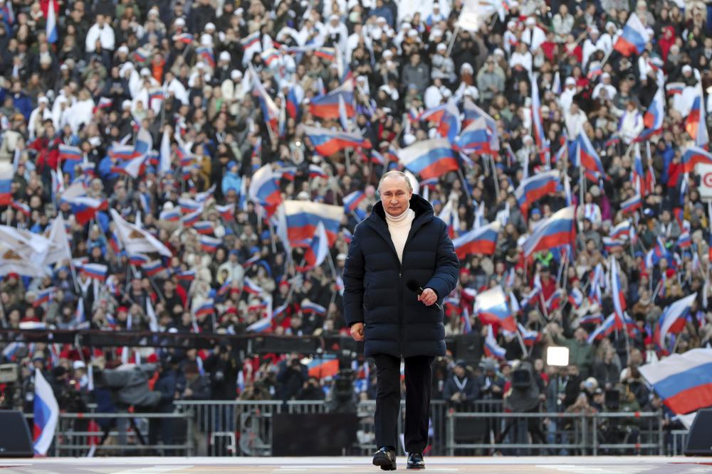 Russian President Vladimir Putin arrives to deliver his speech at the concert marking the eighth anniversary of the referendum on the state status of Crimea and Sevastopol and its reunification with Russia, in Moscow, Russia, Friday.