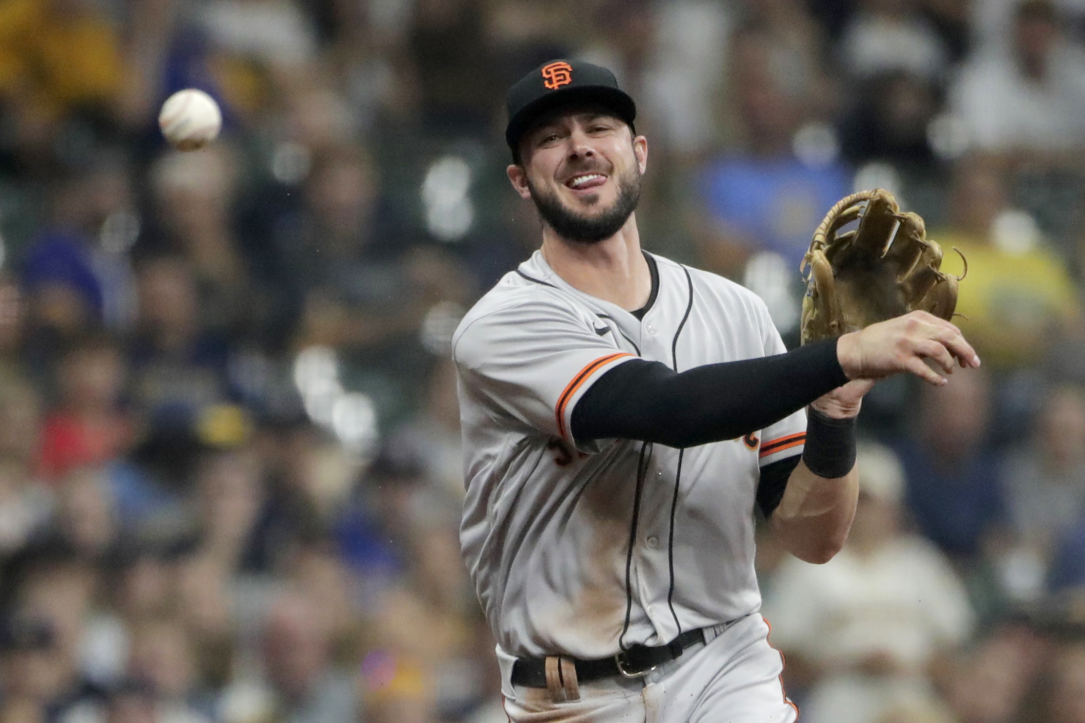 FILE -San Francisco Giants' Kris Bryant throws out Milwaukee Brewers' Avisail Garcia at first base during the first inning of a baseball game Saturday, Aug. 7, 2021, in Milwaukee. Veteran slugger Kris Bryant has agreed to a $182 million, seven-year deal to join the Colorado Rockies, according to a person familiar with the agreement. The person confirmed the deal to The Associated Press on condition of anonymity Wednesday, March 16, 2022 because its completion is pending a successful physical.  