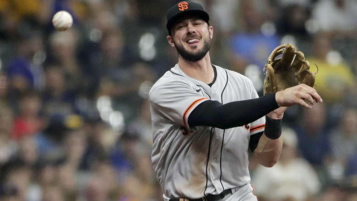 FILE -San Francisco Giants' Kris Bryant throws out Milwaukee Brewers' Avisail Garcia at first base during the first inning of a baseball game Saturday, Aug. 7, 2021, in Milwaukee. Veteran slugger Kris Bryant has agreed to a $182 million, seven-year deal to join the Colorado Rockies, according to a person familiar with the agreement. The person confirmed the deal to The Associated Press on condition of anonymity Wednesday, March 16, 2022 because its completion is pending a successful physical.
