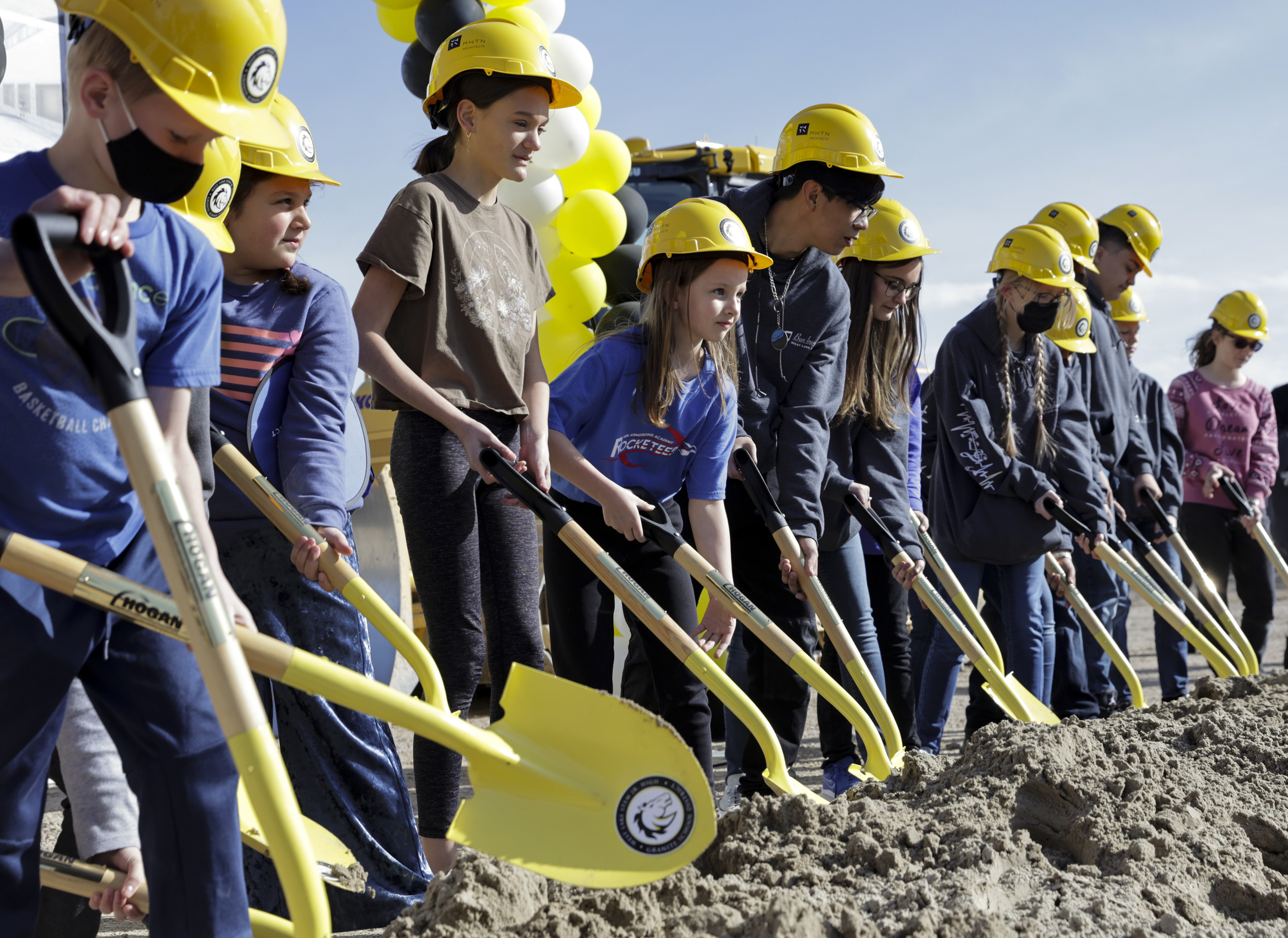 Students turn over soil during the groundbreaking for West Lake STEM Junior High in West Valley City on Friday. Two years ago to the day, the school was damaged in an earthquake.