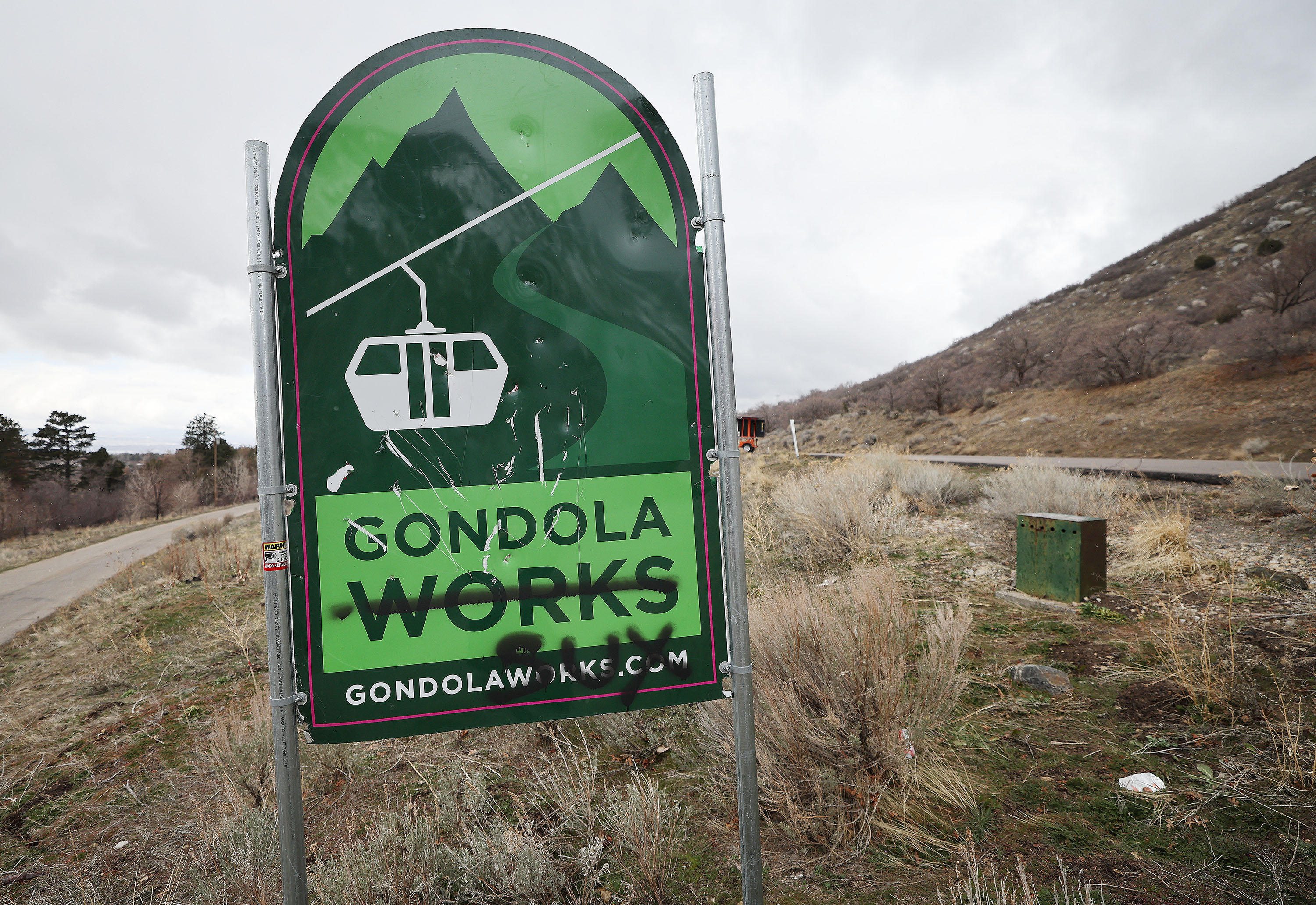 A Gondola Works sign that has graffiti on it in is pictured near Little Cottonwood Canyon on Wednesday. Rep. Gay Lynn Bennion, R-Cottonwood Heights, wants to audit the Utah Department of Transportation to see how outside influences impact the National Environmental Policy Act process.