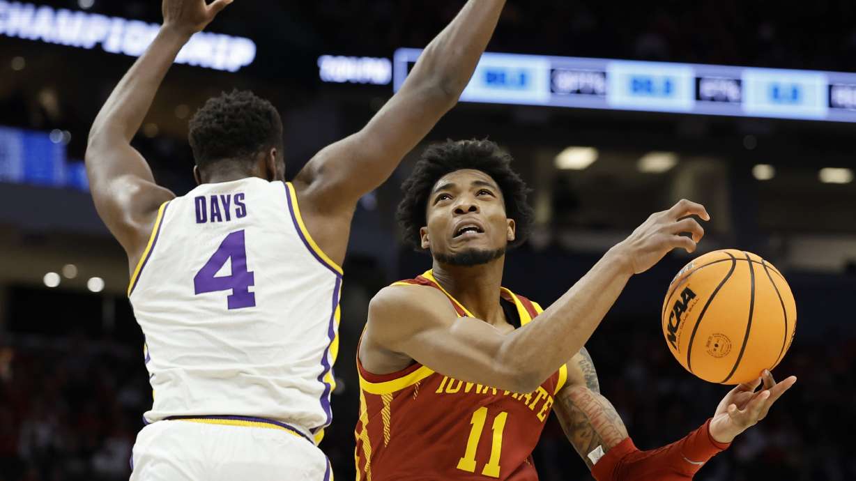 Iowa State's Tyrese Hunter shoots past LSU's Darius Days during the first half of a first round NCAA college basketball tournament game Friday, March 18, 2022, in Milwaukee.