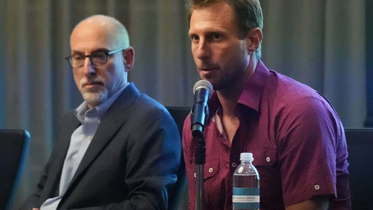 New York Mets pitcher Max Scherzer, right, speaks as Bruce Meyer, chief union negotiator, listens during a news conference Tuesday, March 1, 2022, in Jupiter, Fla. Major League Baseball has canceled opening day. Commissioner Rob Manfred announced Tuesday the sport will lose regular-season games over a labor dispute for the first time in 27 years after acrimonious lockout talks collapsed in the hours before management's deadline.