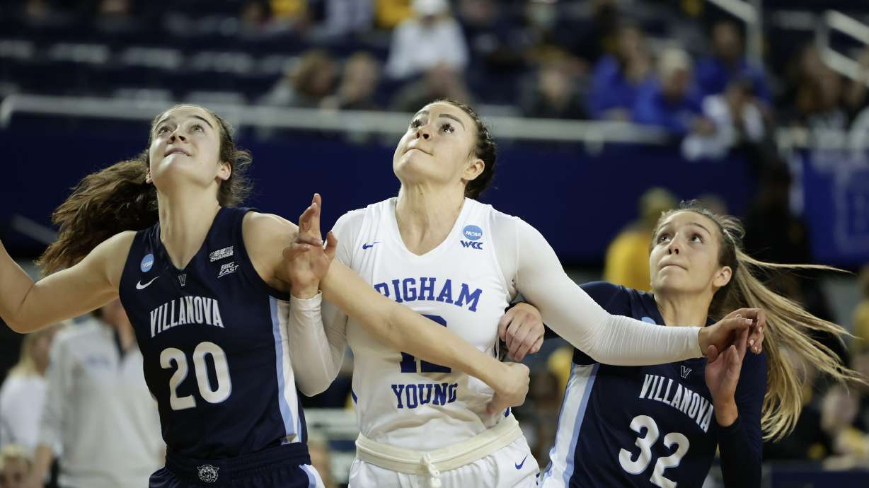 BYU forward Lauren Gustin posts up against villanova's Maddy Siegrist (20) during an NCAA women's basketball tournament first-round game, Saturday, March 19, 2022 in Ann Arbor, Michigan.