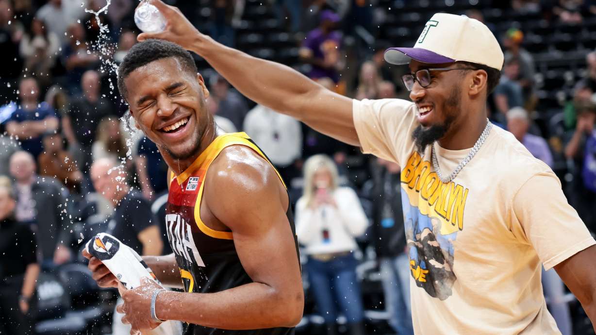 Utah Jazz guard Donovan Mitchell (45) splashes guard Jared Butler (13) with water after the Jazz beat the LA Clippers at Vivint Arena in Salt Lake City on Friday, March 18, 2022.