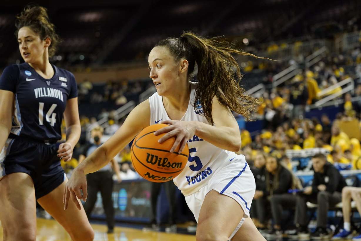 BYU guard Maria Albiero (5) drives as Villanova forward Brianna Herlihy (14) defends during the second half of a college basketball game in the first round of the NCAA tournament, Saturday, March 19, 2022, in Ann Arbor, Mich.
