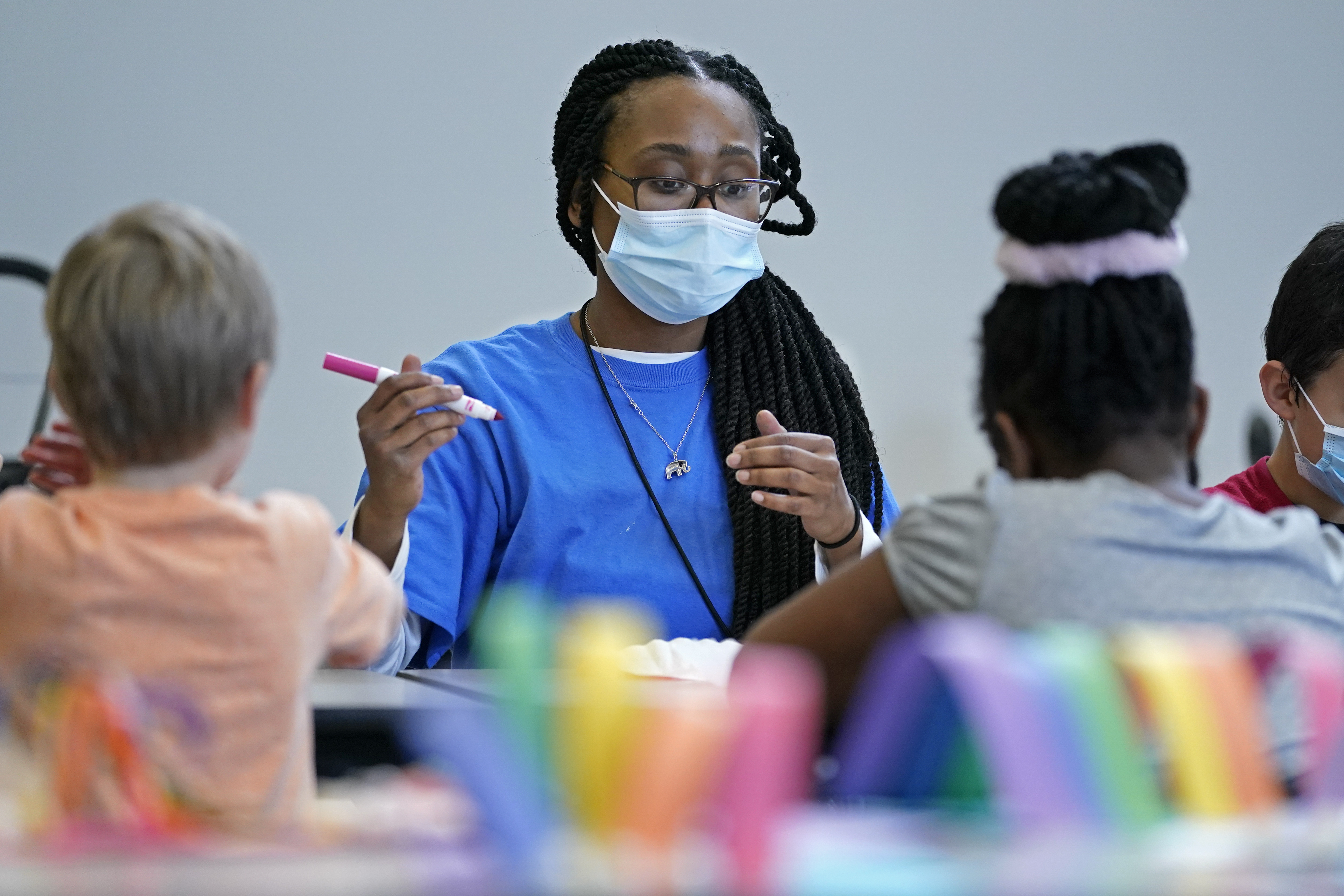 Kiara Beard works with children in a before- and afterschool program operated by the YMCA of Middle Tennessee in Wednesday in Nashville, Tenn. The return to classrooms for the nation's schoolchildren has not meant a return to work for many of their parents who — with workdays that outlast school days — are finding crucial afterschool programs in short supply.