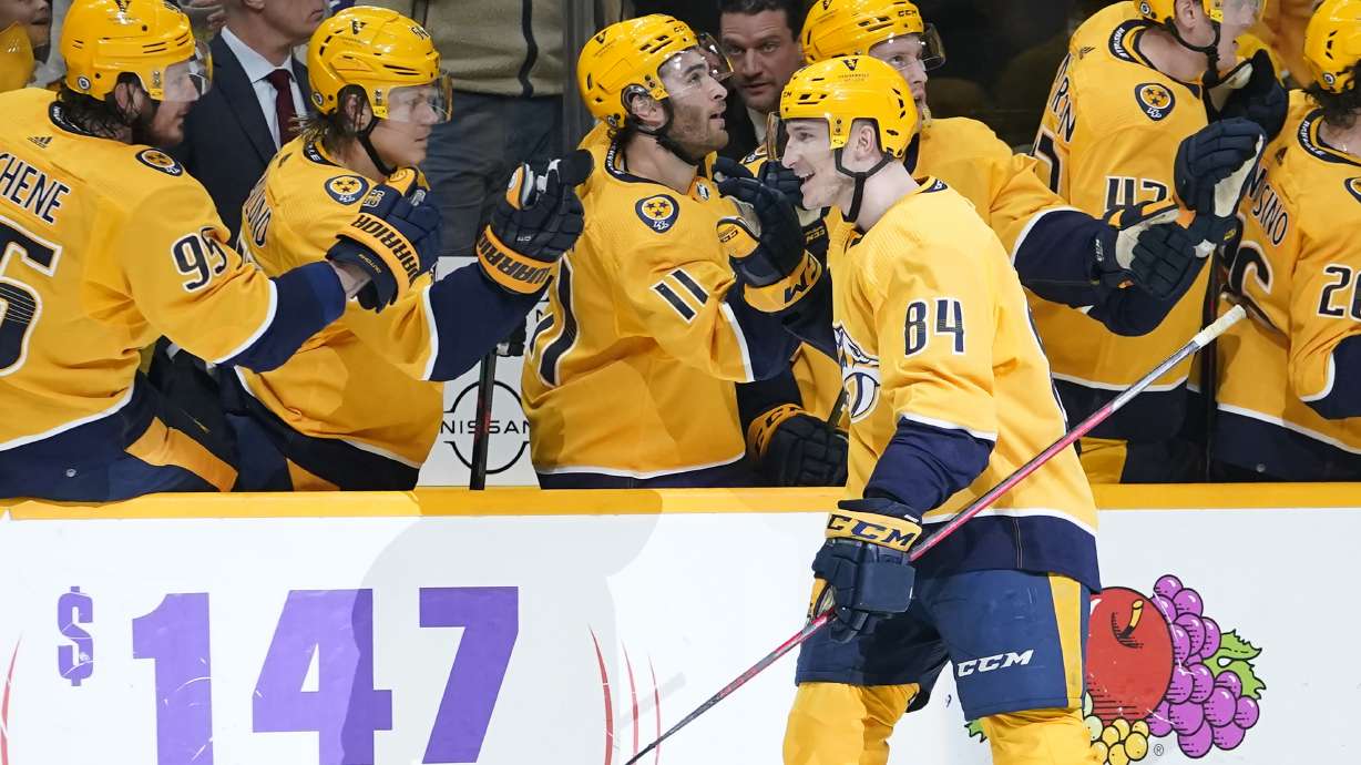 Nashville Predators' Tanner Jeannot (84) is congratulated after scoring a goal against the Toronto Maple Leafs in the first period of an NHL hockey game Saturday, March 19, 2022, in Nashville, Tenn.