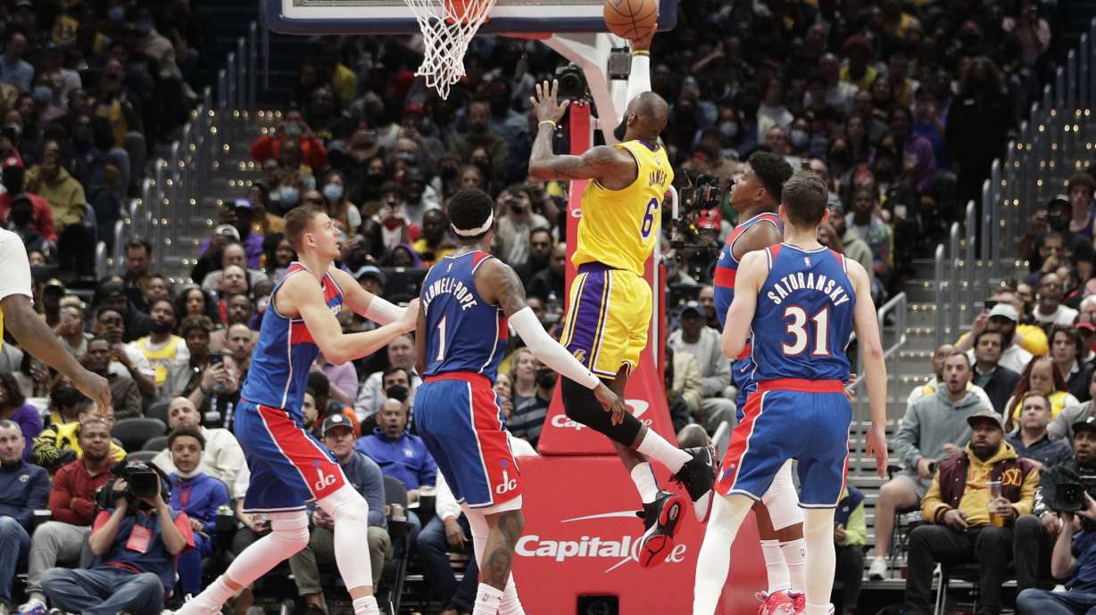 Los Angeles Lakers LeBron James scores as Washington Wizards' Kentavious Caldwell-Pope (1) defends during the first half of an NBA basketball game, Saturday, March 19, 2022, in Washington. LeBron James moved into second place on the NBA’s career scoring list Saturday night, surpassing Karl Malone in the second quarter of the Los Angeles Lakers’ game at Washington.