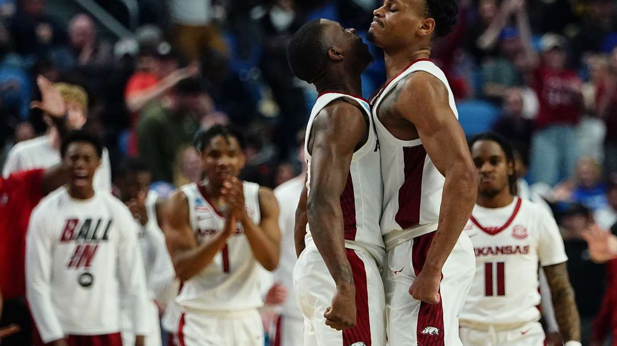 Arkansas guard Davonte Davis, left, and guard Au'Diese Toney celebrate during the second half of the team's college basketball game against New Mexico State in the second round of the NCAA men's tournament Saturday, March 19, 2022, in Buffalo, N.Y.