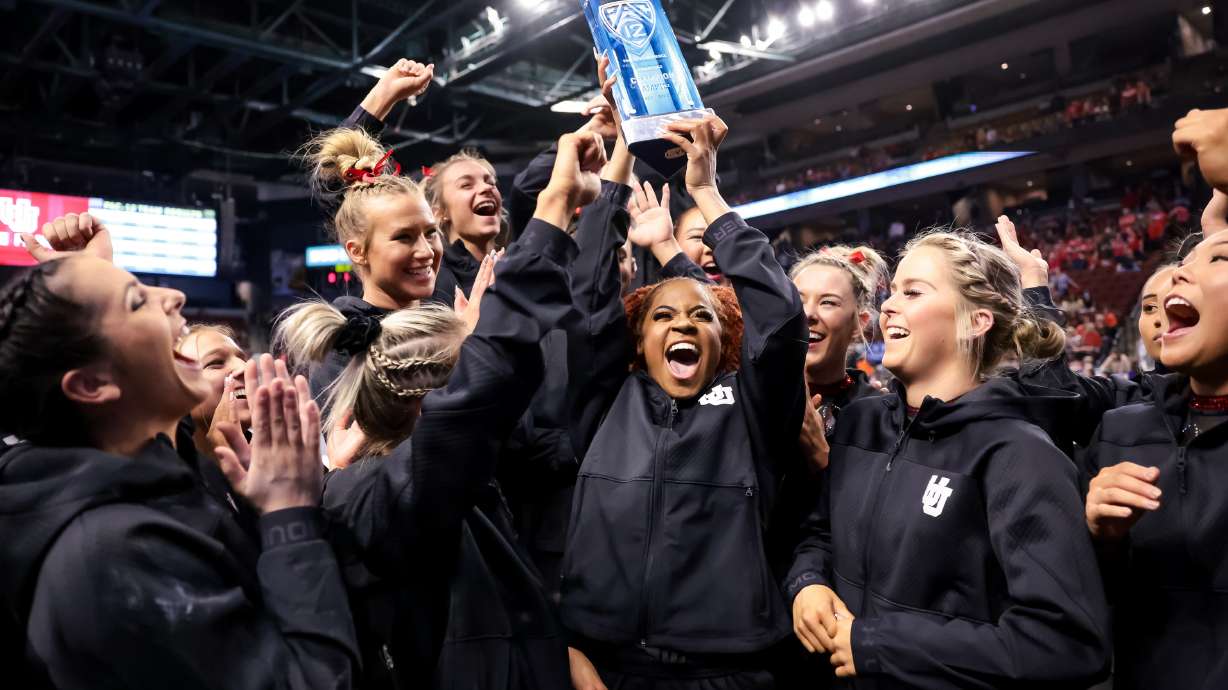 Utah accepts their trophy after winning at the Pac-12 women’s gymnastics championship at the Maverik Center in West Valley City on Saturday, March 19, 2022.