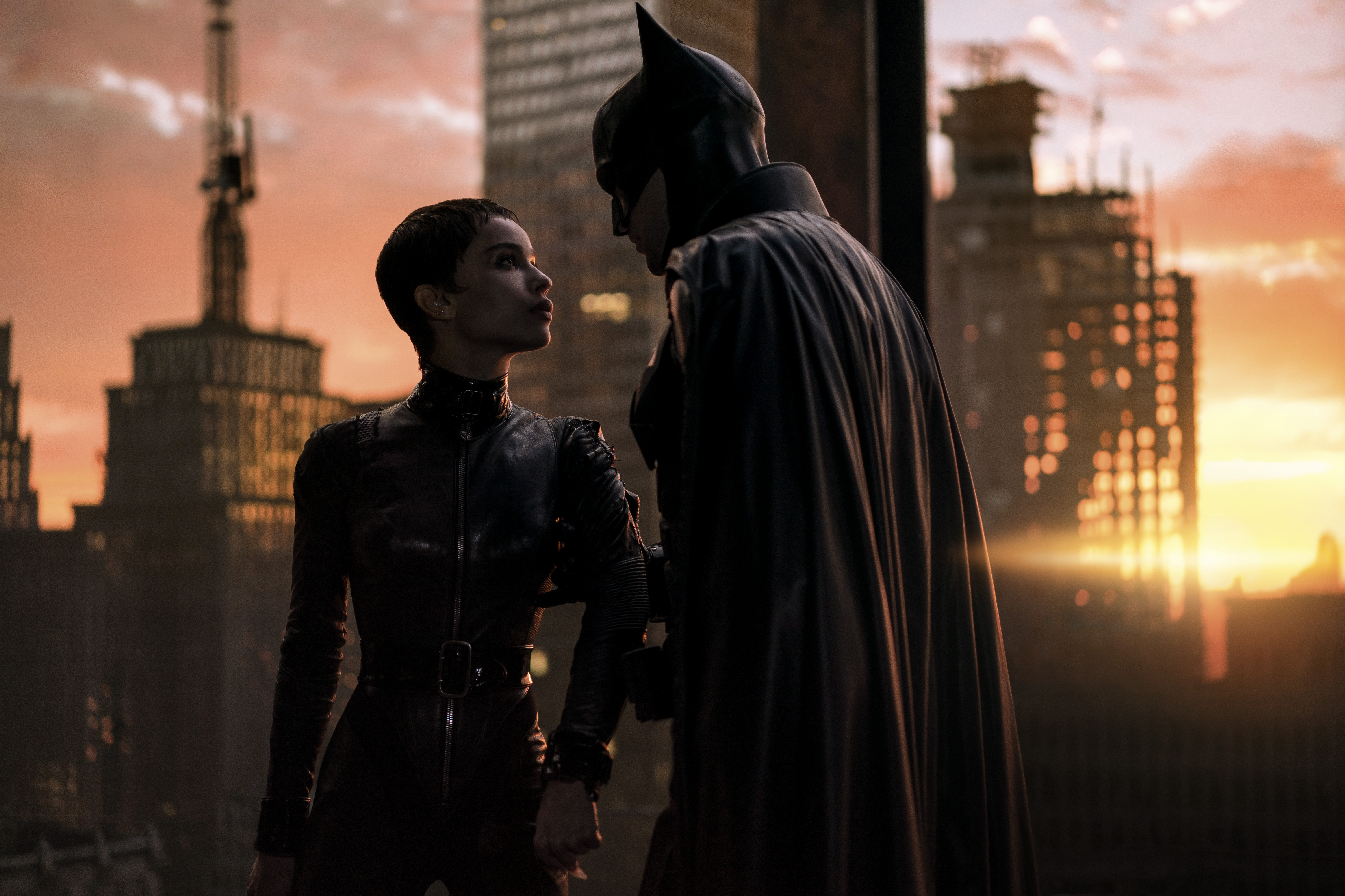 This image released by Warner Bros. Pictures shows Zoe Kravitz, left, and Robert Pattinson in a scene from "The Batman."  “The Batman” is still going strong three weeks into its theatrical run, with a tight grip on the top spot at the box office.
