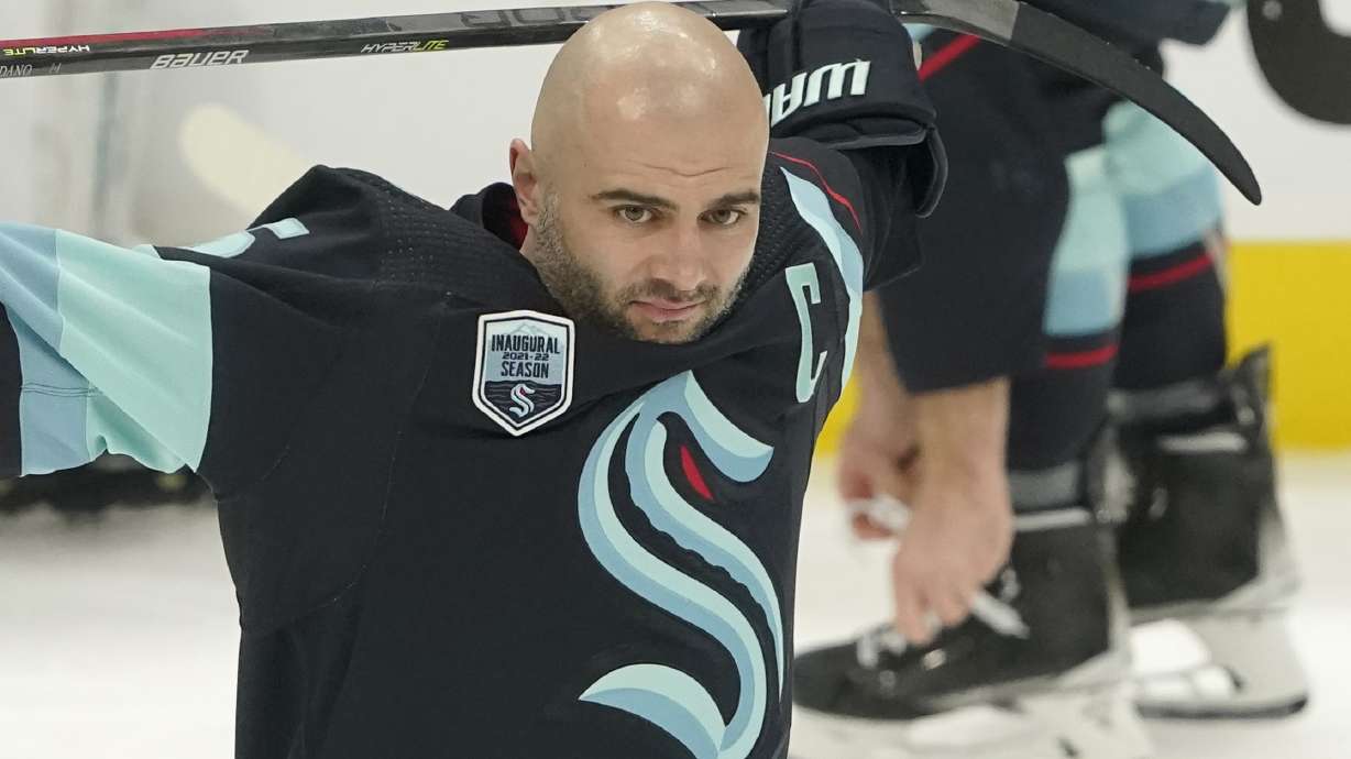 Seattle Kraken defenseman Mark Giordano holds his stick during warmups before an NHL hockey game against the Tampa Bay Lightning, Wednesday, March 16, 2022, in Seattle. Giordano was honored before the game for his 1000th career NHL game, which took place March 5, 2022 on the road against the Washington Capitals.