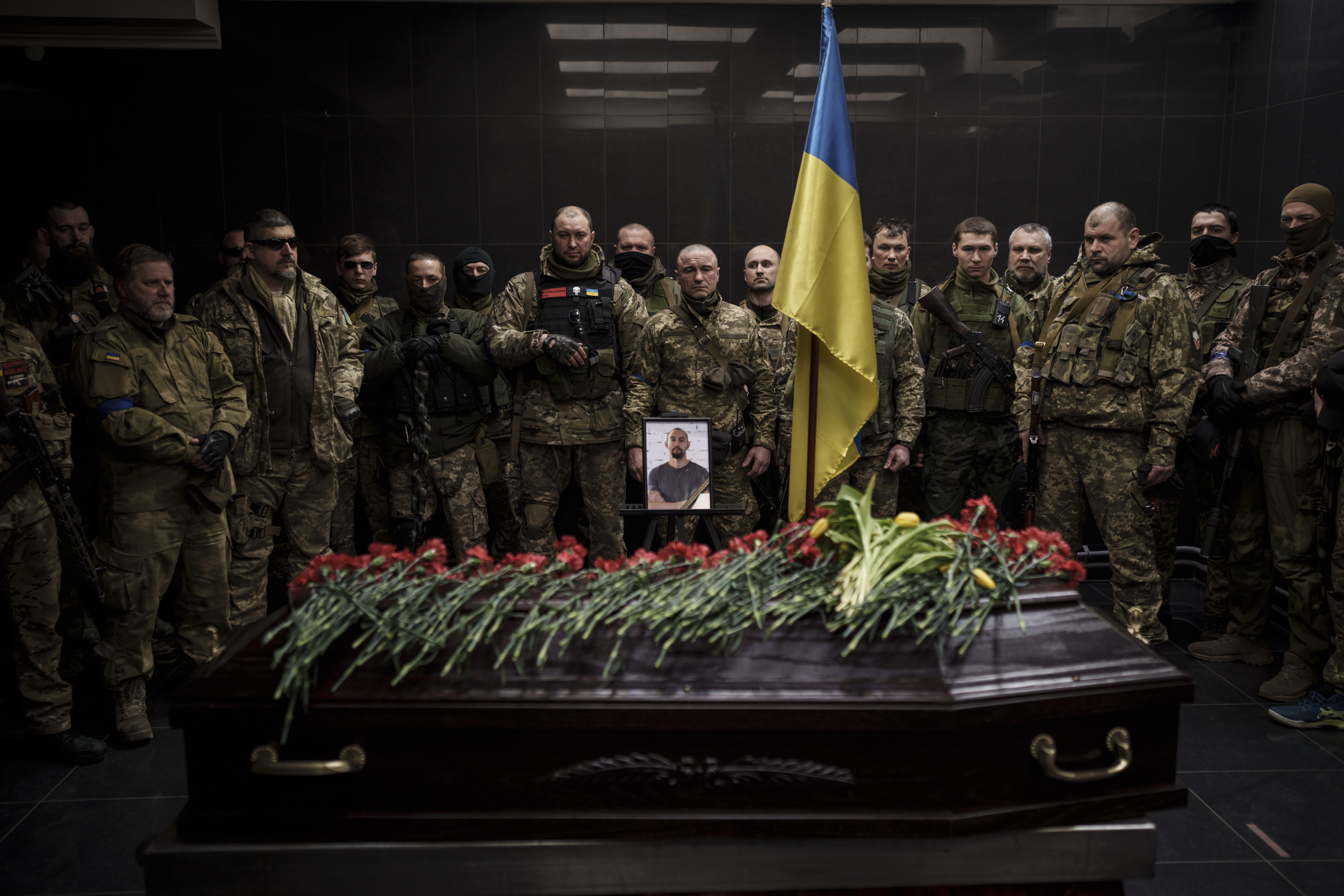 Ukrainian servicemen attend the funeral ceremony of marine Alexandr Khovtun, in Kyiv, Ukraine, Sunday. Khovtun died in combat in the town of Huta-Mezhyhirska, north of Kyiv.
