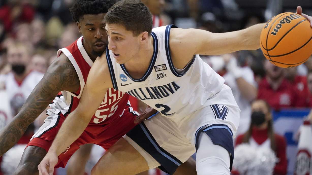 Villanova's Collin Gillespie (2) tries to get the ball past Ohio State's Jamari Wheeler (55) during the first half of a college basketball game in the second round of the NCAA tournament, Sunday, March 20, 2022, in Pittsburgh.