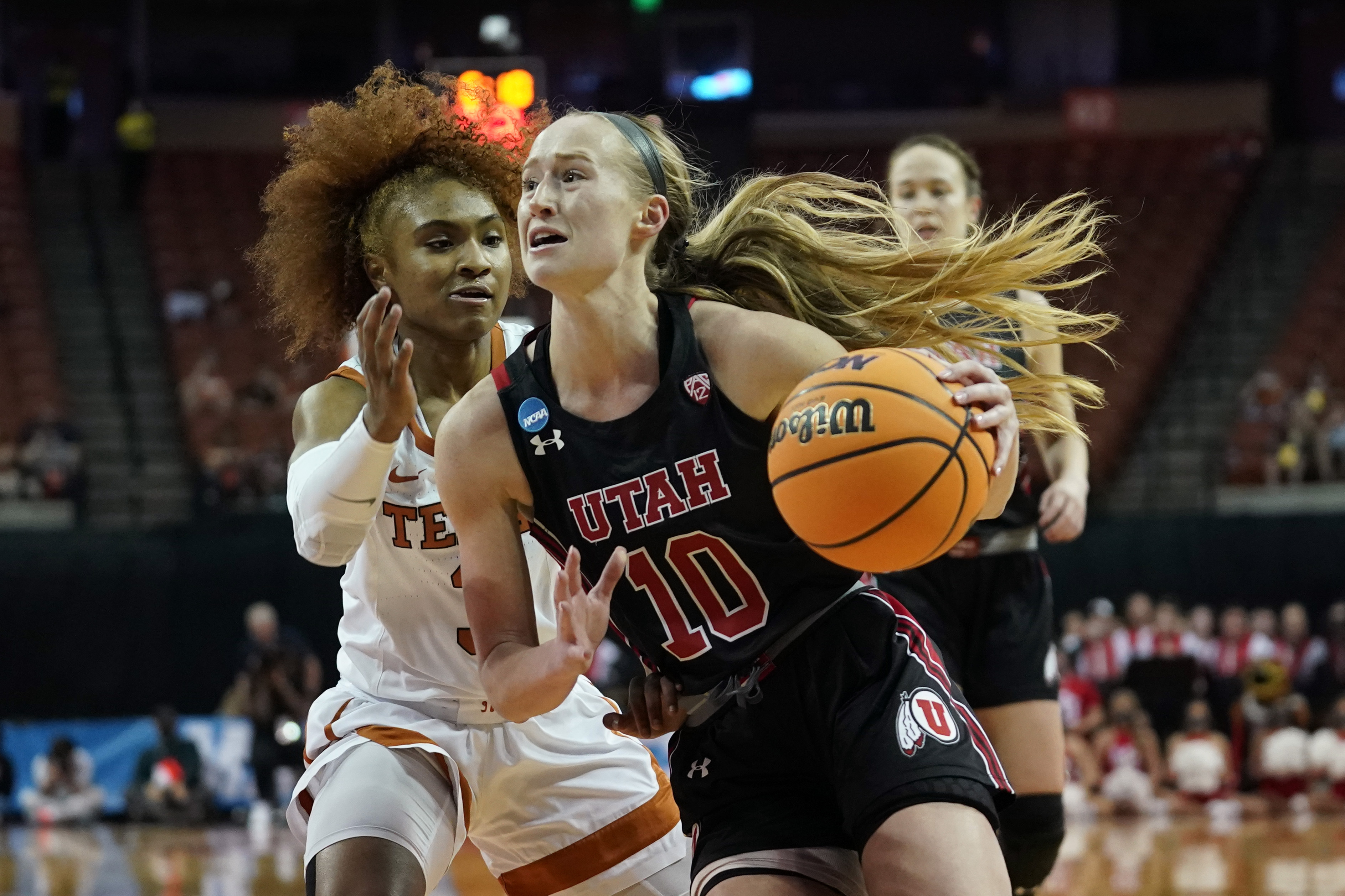 Utah guard Dru Gylten (10) drives past Texas guard Rori Harmon (3) during the first half of a college basketball game in the second round of the NCAA women's tournament, Sunday, March 20, 2022, in Austin, Texas.