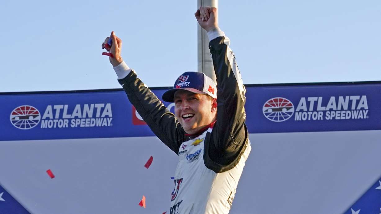 William Byron (24) reacts as he climbs out of his car in Victory Lane after winning a NASCAR Cup Series auto race at Atlanta Motor Speedway in Hampton, Ga., Sunday, March 20, 2022.