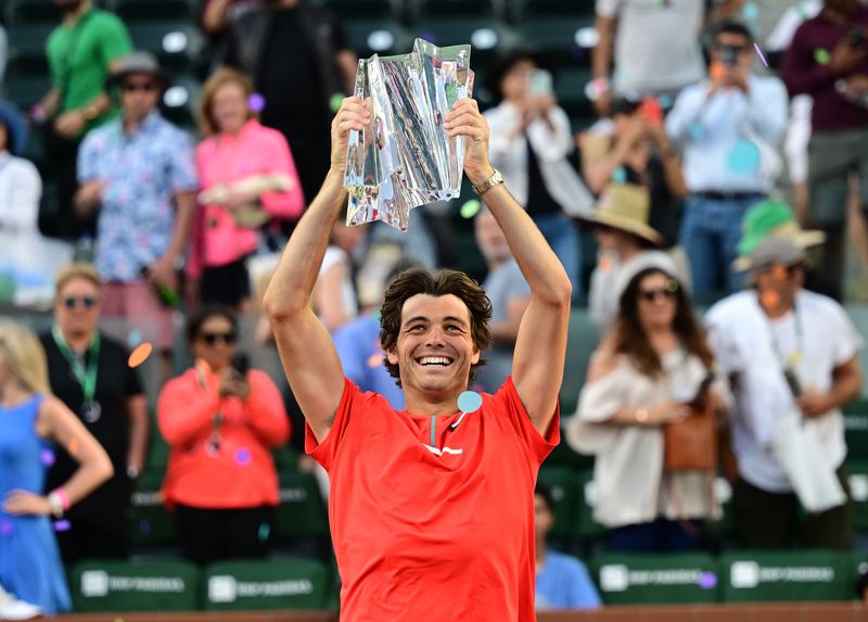 Mar 20, 2022; Indian Wells, CA, USA;   Taylor Fritz (USA) holds the championship trophy after defeating Rafael Nadal (ESP) in the men’s final at the Indian Wells Tennis Garden.