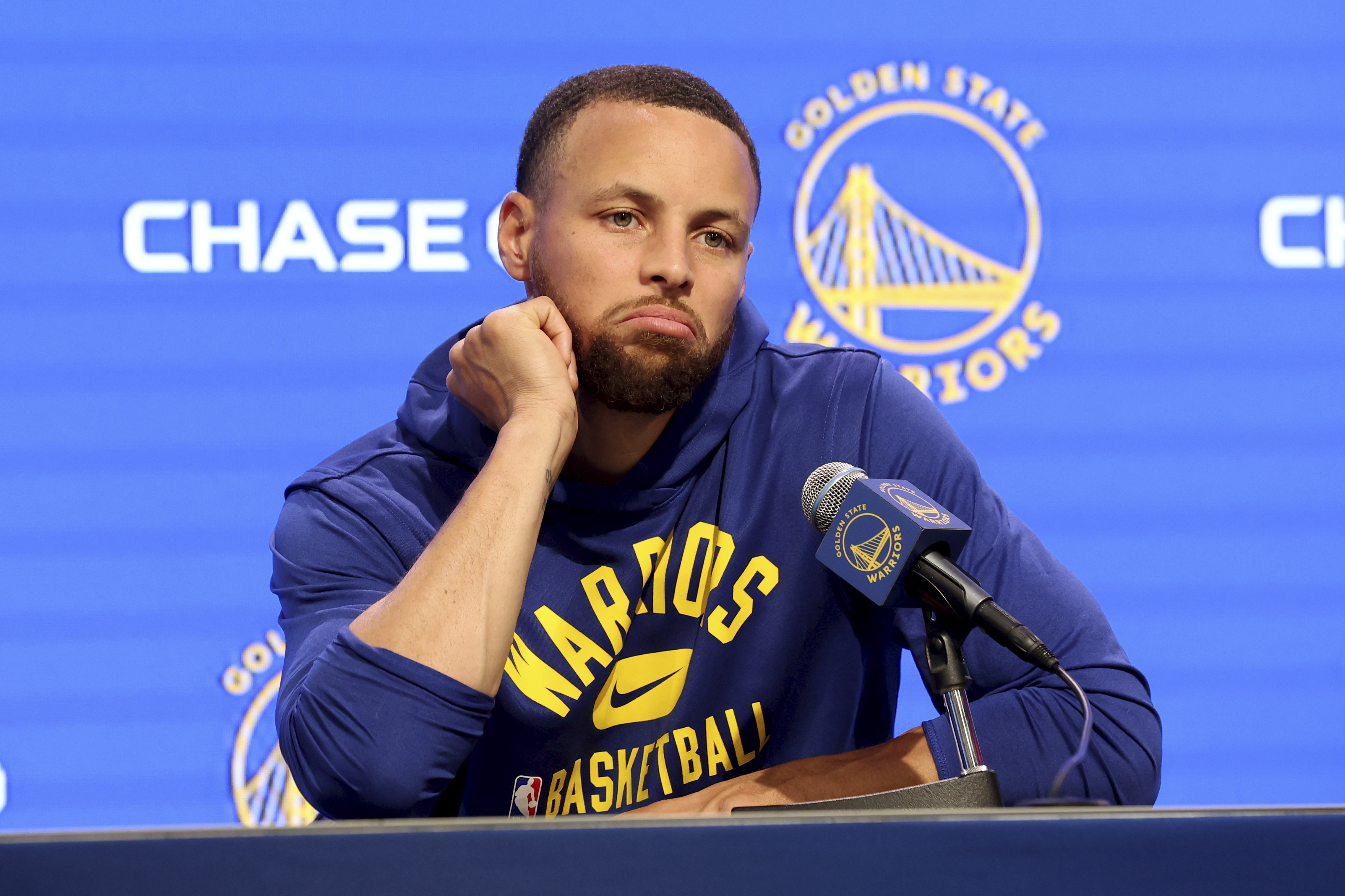 Golden State Warriors guard Stephen Curry talks to the media about his injury before an NBA basketball game against the San Antonio Spurs in San Francisco, Sunday, March 20, 2022. 
