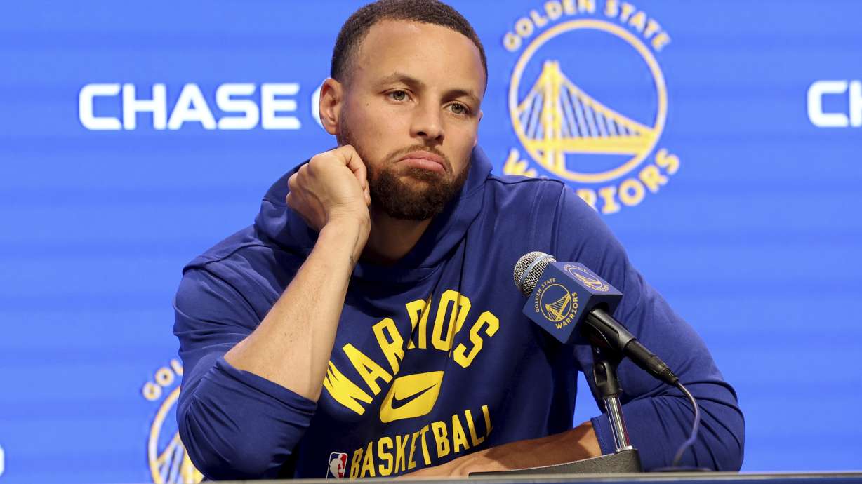 Golden State Warriors guard Stephen Curry talks to the media about his injury before an NBA basketball game against the San Antonio Spurs in San Francisco, Sunday, March 20, 2022.