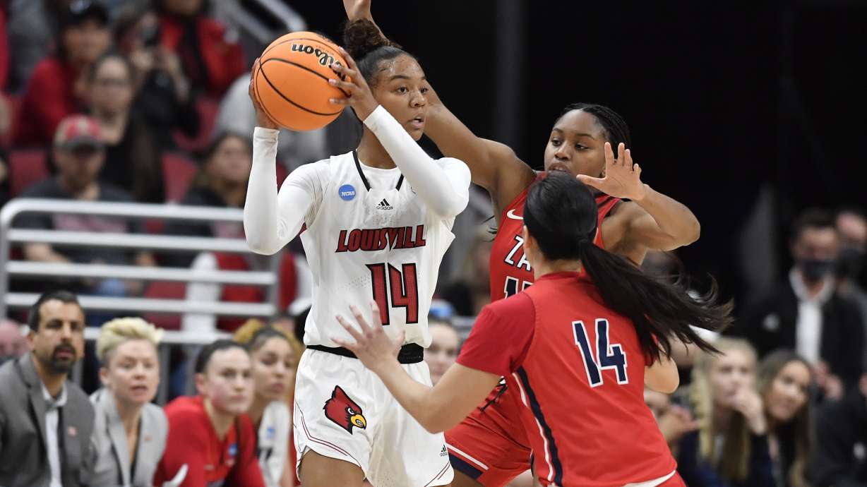 Louisville guard Kianna Smith (14) looks for help from pressure by Gonzaga guard Kaylynne Truong (14) and forward Yvonne Ejim (15) during the first half of a women's NCAA tournament college basketball second-round game in Louisville, Ky., Sunday, March 20, 2022.