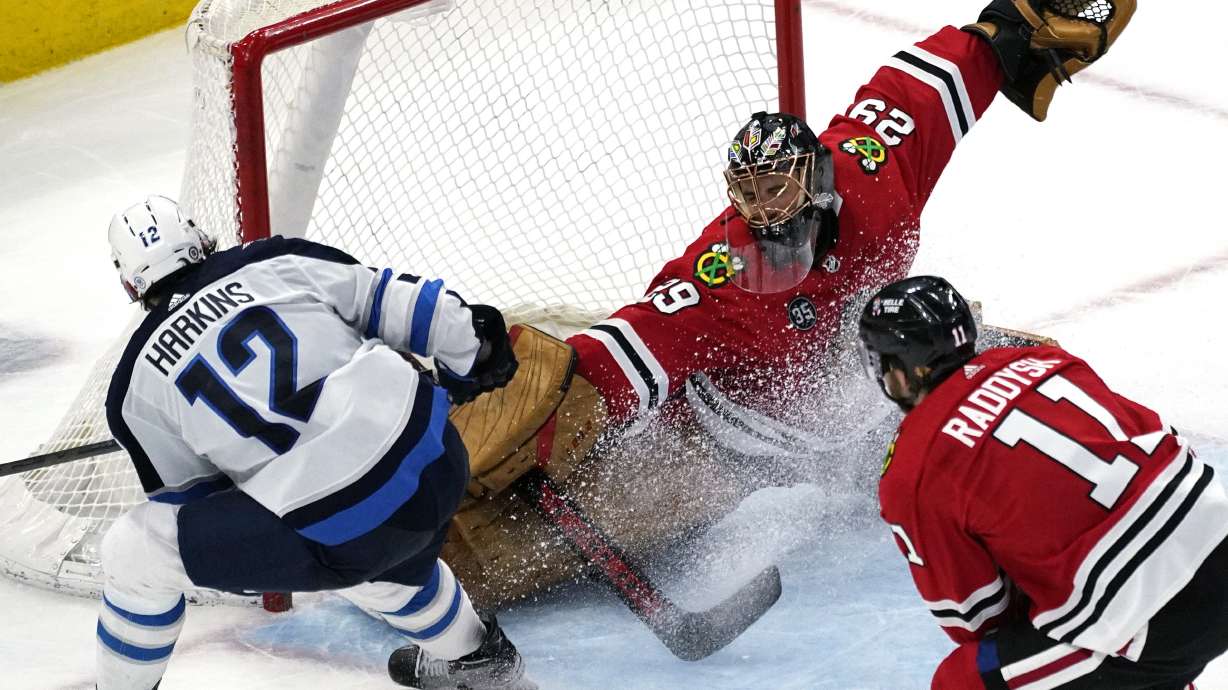 Chicago Blackhawks goaltender Marc-Andre Fleury (29) cannot make the save on a goal by Winnipeg Jets center Jansen Harkins (12) during the second period of an NHL hockey game in Chicago, Sunday, March 20, 2022.