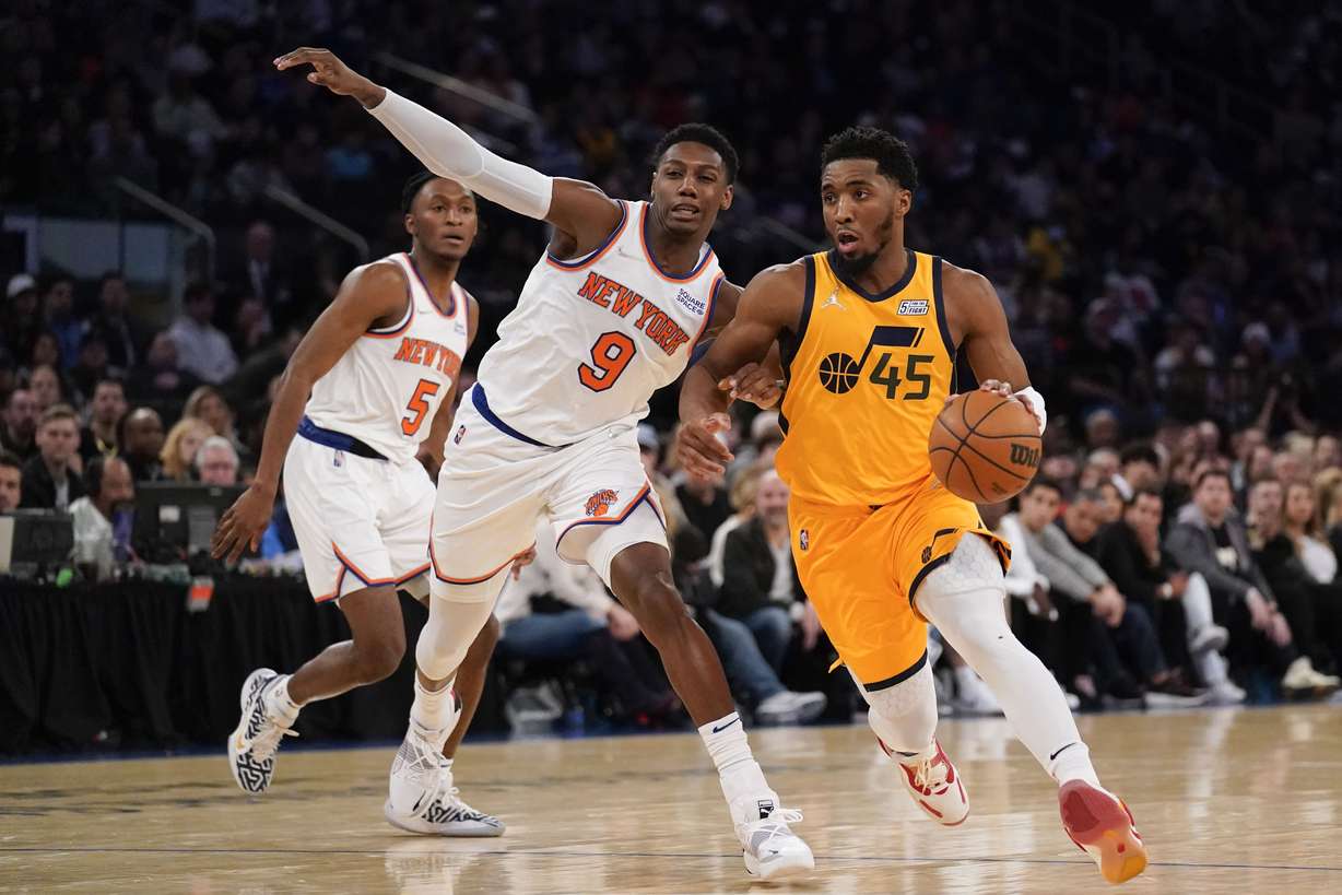 Utah Jazz's Donovan Mitchell (45), right, makes a move around New York Knicks' RJ Barrett (9) during the second half of an NBA basketball game, Sunday, March 20, 2022, in New York.