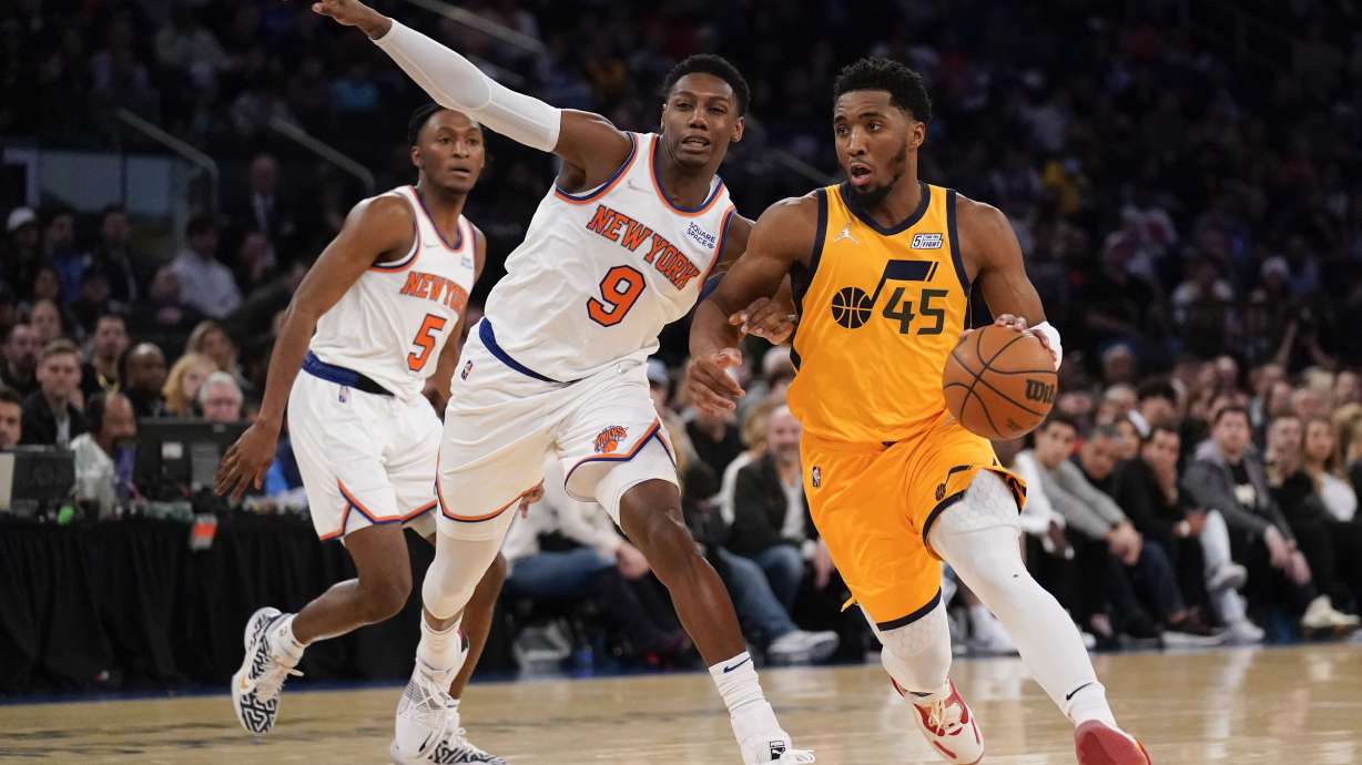 Utah Jazz's Donovan Mitchell (45), right, makes a move around New York Knicks' RJ Barrett (9) during the second half of an NBA basketball game, Sunday, March 20, 2022, in New York.