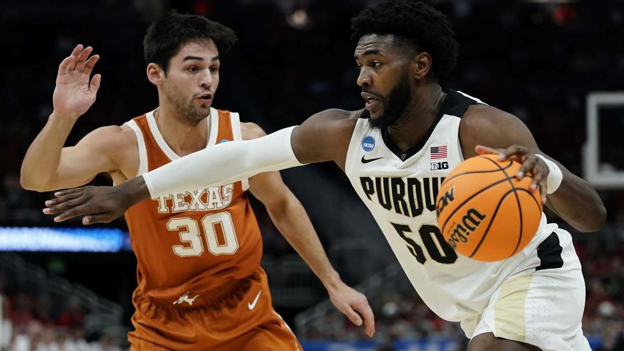 Purdue's Trevion Williams gets past Texas's Brock Cunningham during the first half of a second-round NCAA college basketball tournament game Sunday, March 20, 2022, in Milwaukee.