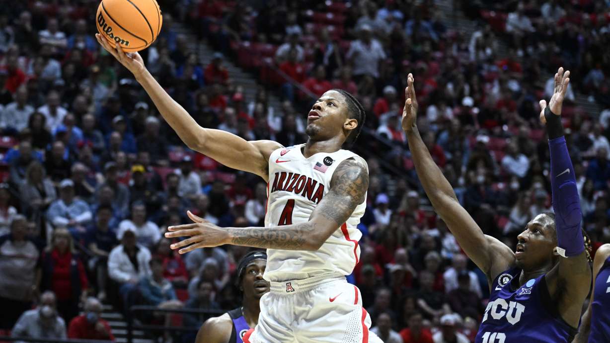 Arizona guard Dalen Terry, left, puts up a shot against the defense of TCU guard Damion Baugh (10) during the second half of a second-round NCAA college basketball tournament game, Sunday, March 20, 2022, in San Diego.
