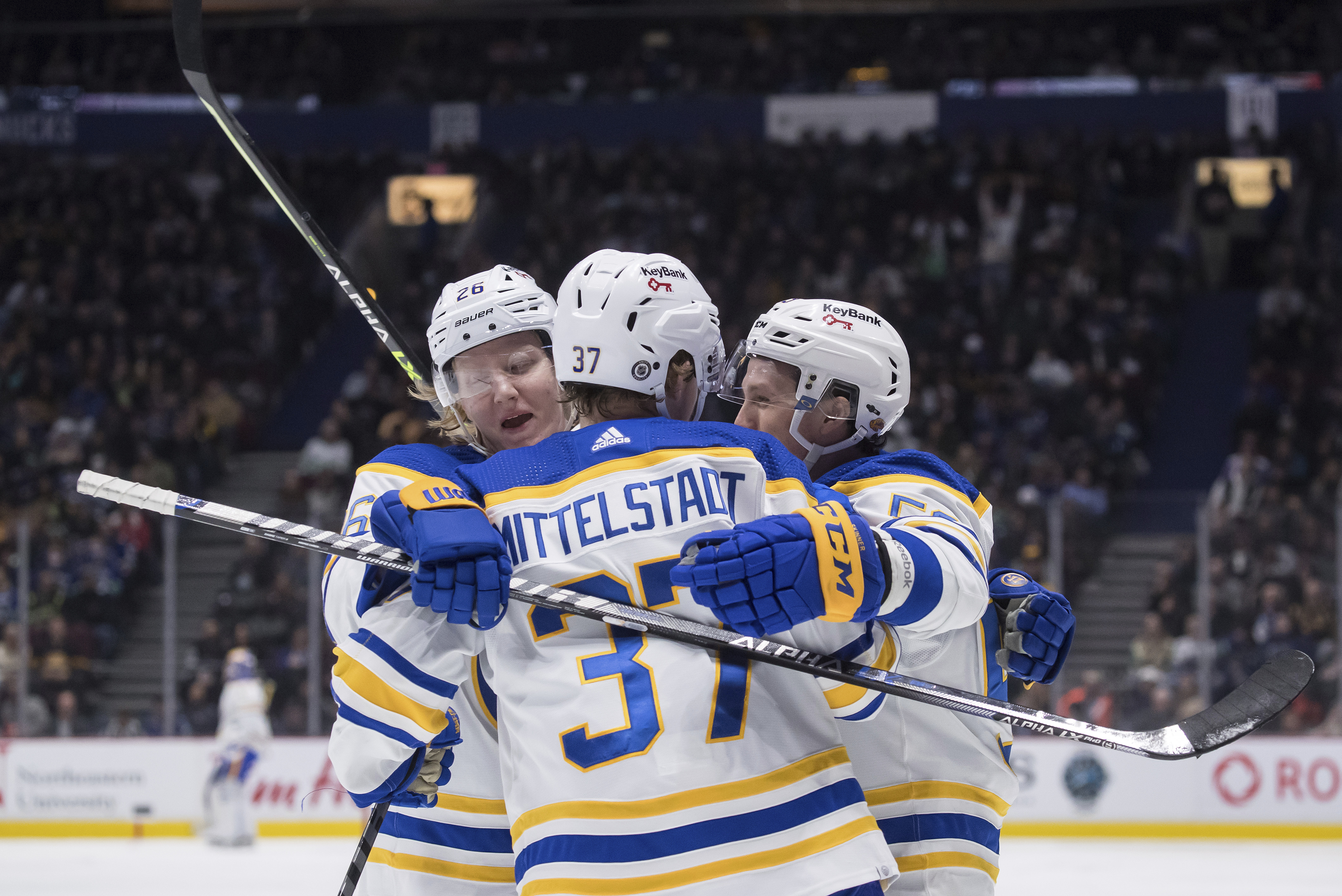 Buffalo Sabres' Jeff Skinner, right, celebrates his goal with teammates Rasmus Dahlin, of Sweden, left, and Casey Mittelstadt during the second period of an NHL hockey game against the Vancouver Canucks, in Vancouver, British Columbia, Sunday, March 20, 2022. 