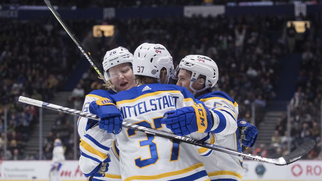 Buffalo Sabres' Jeff Skinner, right, celebrates his goal with teammates Rasmus Dahlin, of Sweden, left, and Casey Mittelstadt during the second period of an NHL hockey game against the Vancouver Canucks, in Vancouver, British Columbia, Sunday, March 20, 2022.