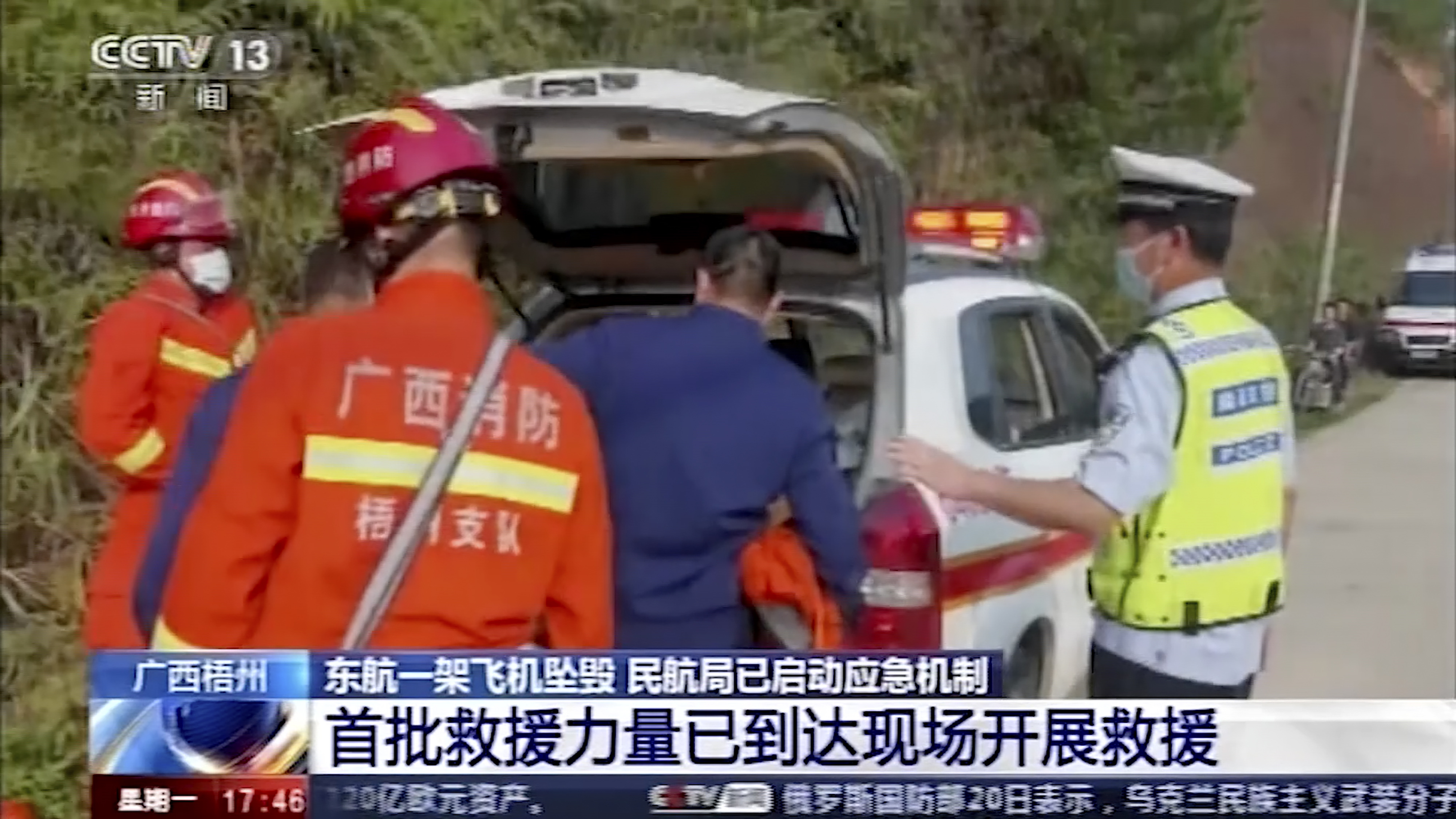 In this image taken from video, emergency personnel prepare to travel to the site of a plane crash near Wuzhou in southwestern China's Guangxi Zhuang Autonomous Region, Monday.