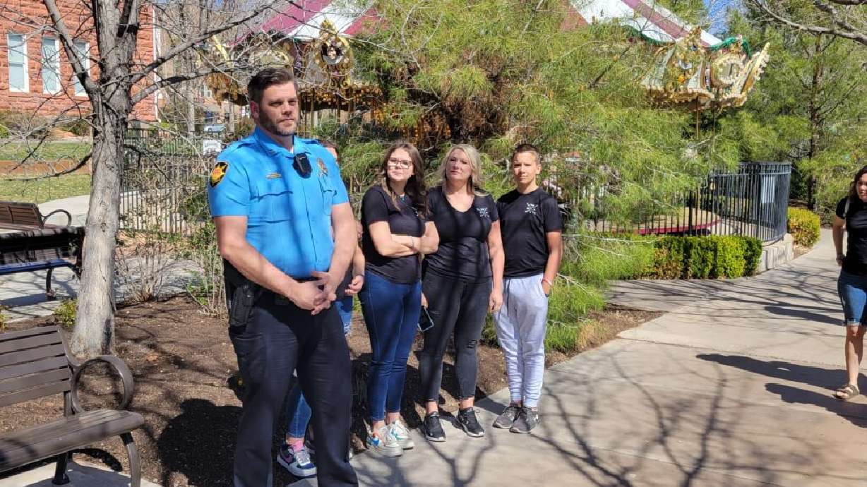 Capt. Jeff Bahlmann speaks alongside St. George police officer Adam Ashworth’s family at the dedication of a memorial bench in his honor at Town Square Park, St. George, Friday.