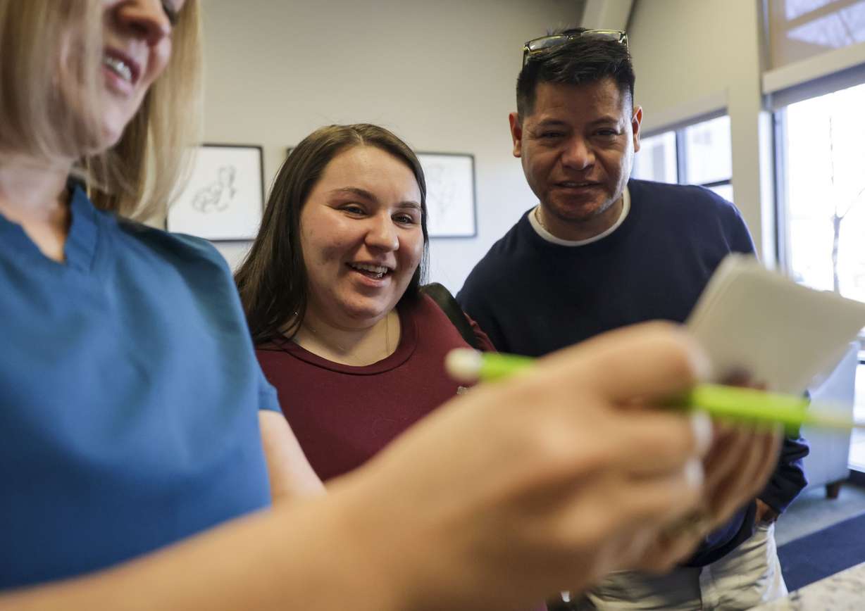 Becky Greene, manager of Fetal Fotos, left, shows Angelina and Roberto Castorena their third child’s ultrasound prints at Fetal Fotos in Murray on Monday, March 14.