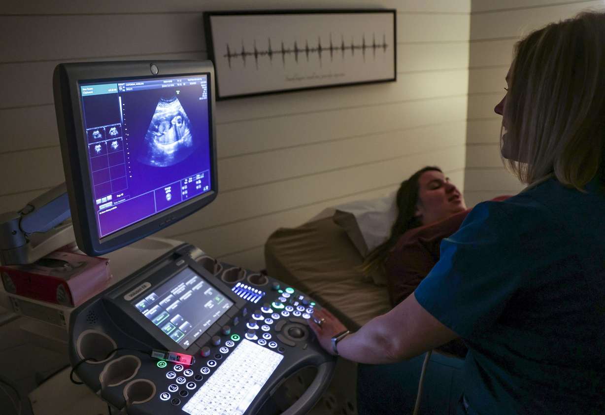 Becky Greene, manager of Fetal Fotos, performs an ultrasound on Angelina Castorena during her third pregnancy at Fetal Fotos in Murray on Monday, March 14.