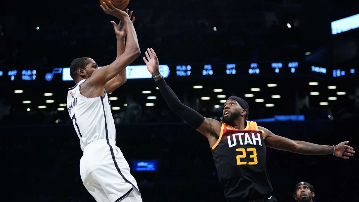 Brooklyn Nets' Kevin Durant (7) shoots over Utah Jazz's Royce O'Neale (23) during the first half of an NBA basketball game Monday, March 21, 2022, in New York.